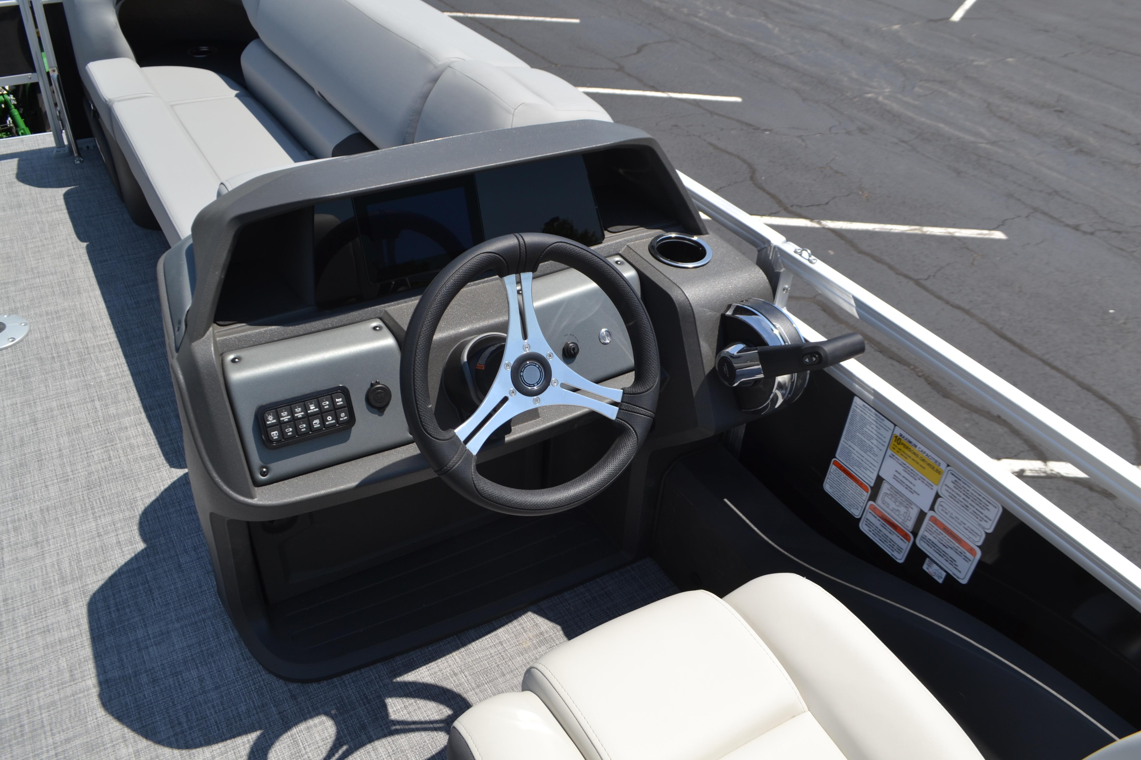 2026 Sun Tracker SportFish 22 DLX boat helm with steering wheel and controls.