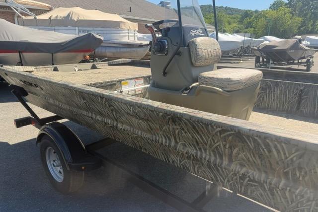 2026 Tracker Grizzly 1860 CC boat on trailer, featuring camouflage design.