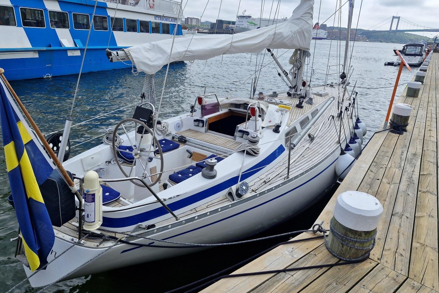 1976 Nautor Swan 38 sailboat docked, featuring sleek design and Swedish flag.