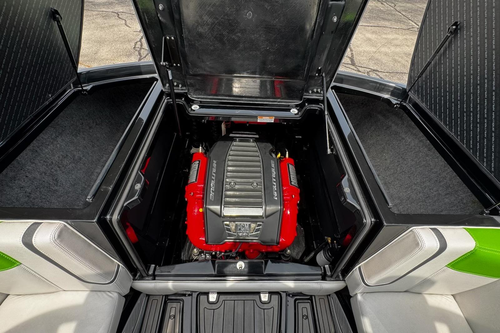 2014 Nautique Super Air Nautique G21 engine compartment with red engine cover.