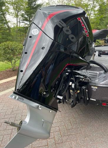 2025 Ranger Z518 boat with a powerful 200 horsepower outboard motor, parked on a brick driveway.