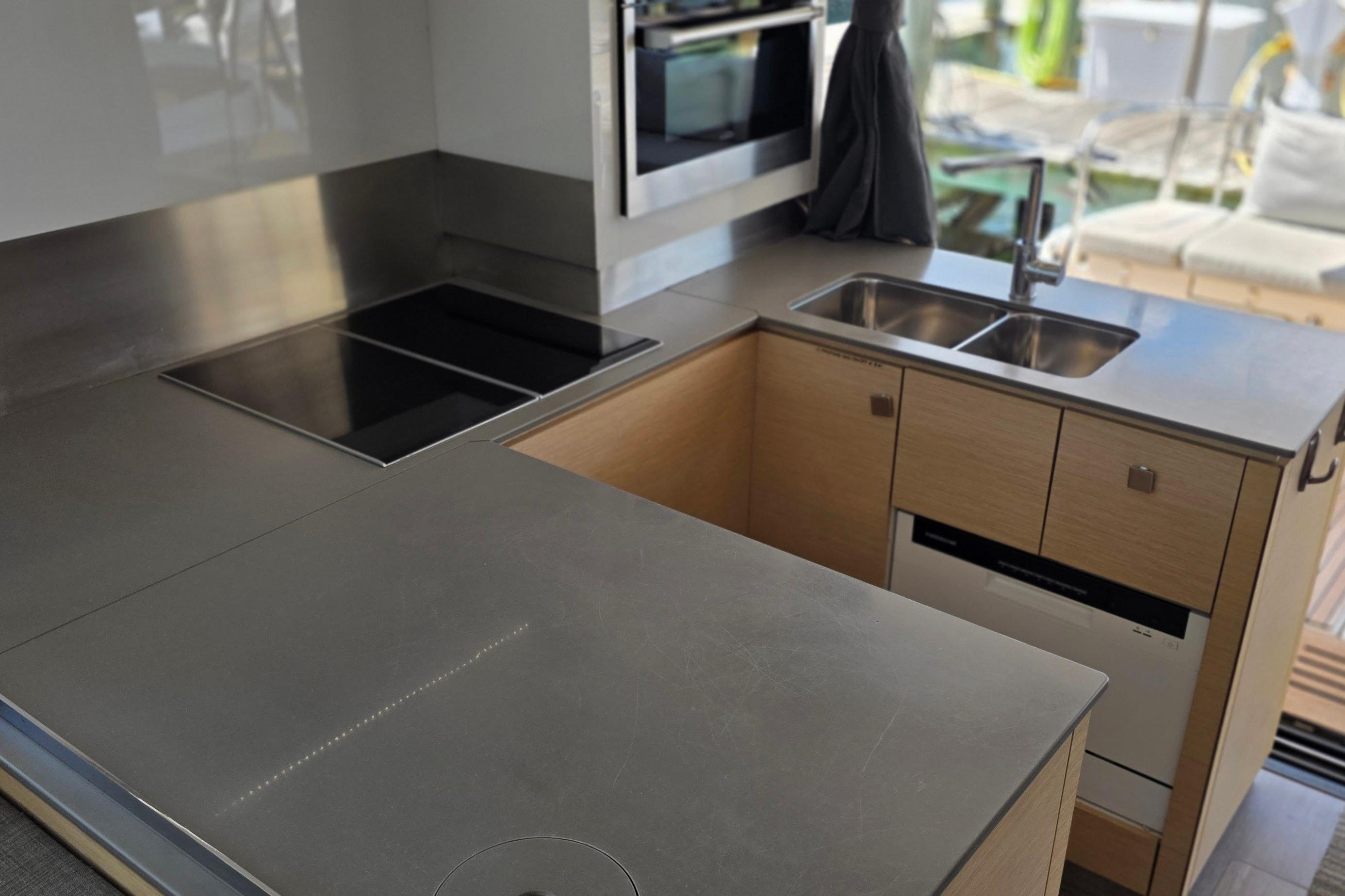 Modern kitchen in 2018 Fountaine Pajot Motor Yacht 44 with sleek countertops and appliances.