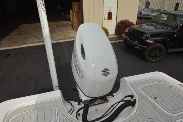 2021 Sea Pro 228 Bay boat with Suzuki outboard motor in a parking area.