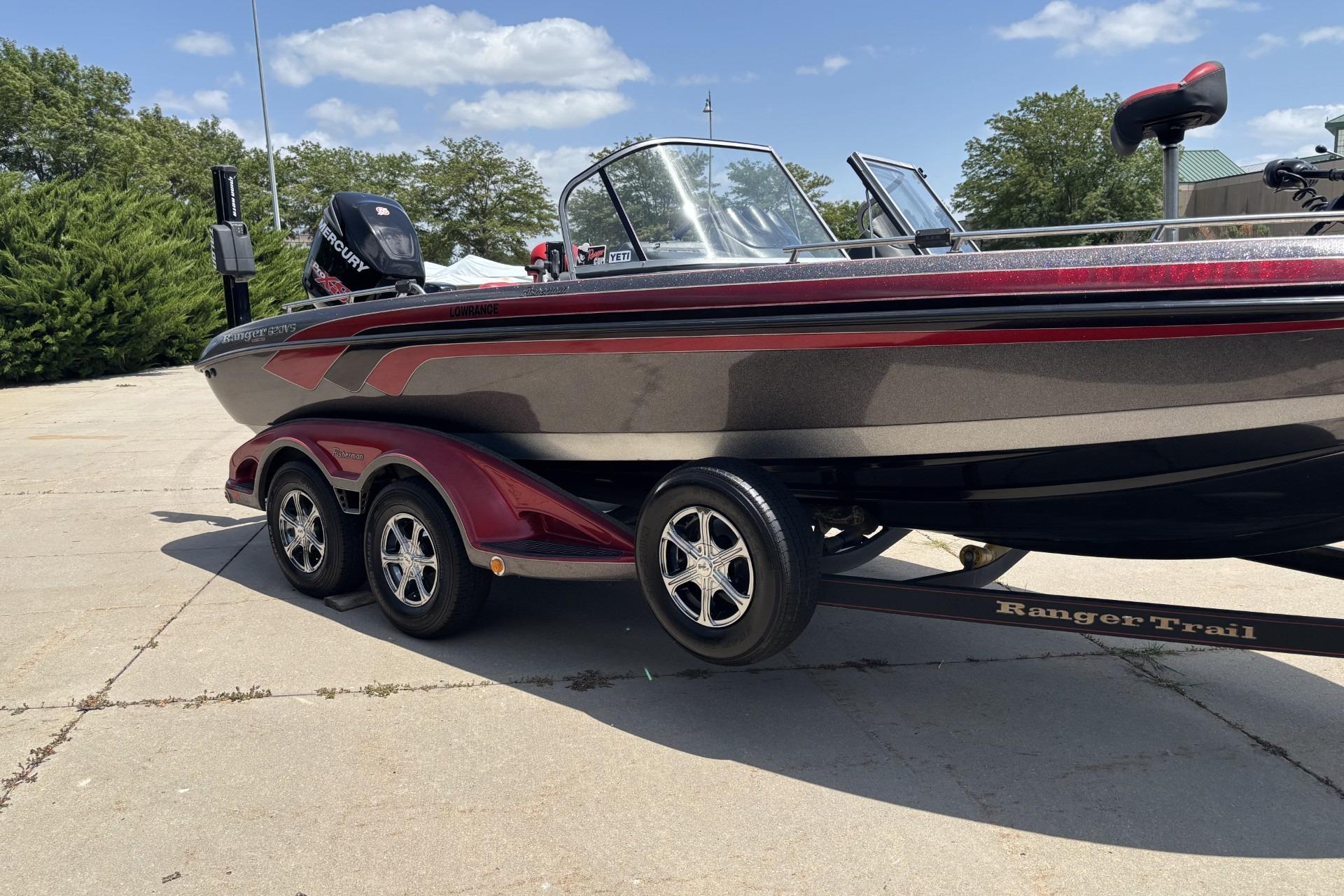 2011 Ranger 620 VS boat on trailer, parked outdoors under a clear sky.
