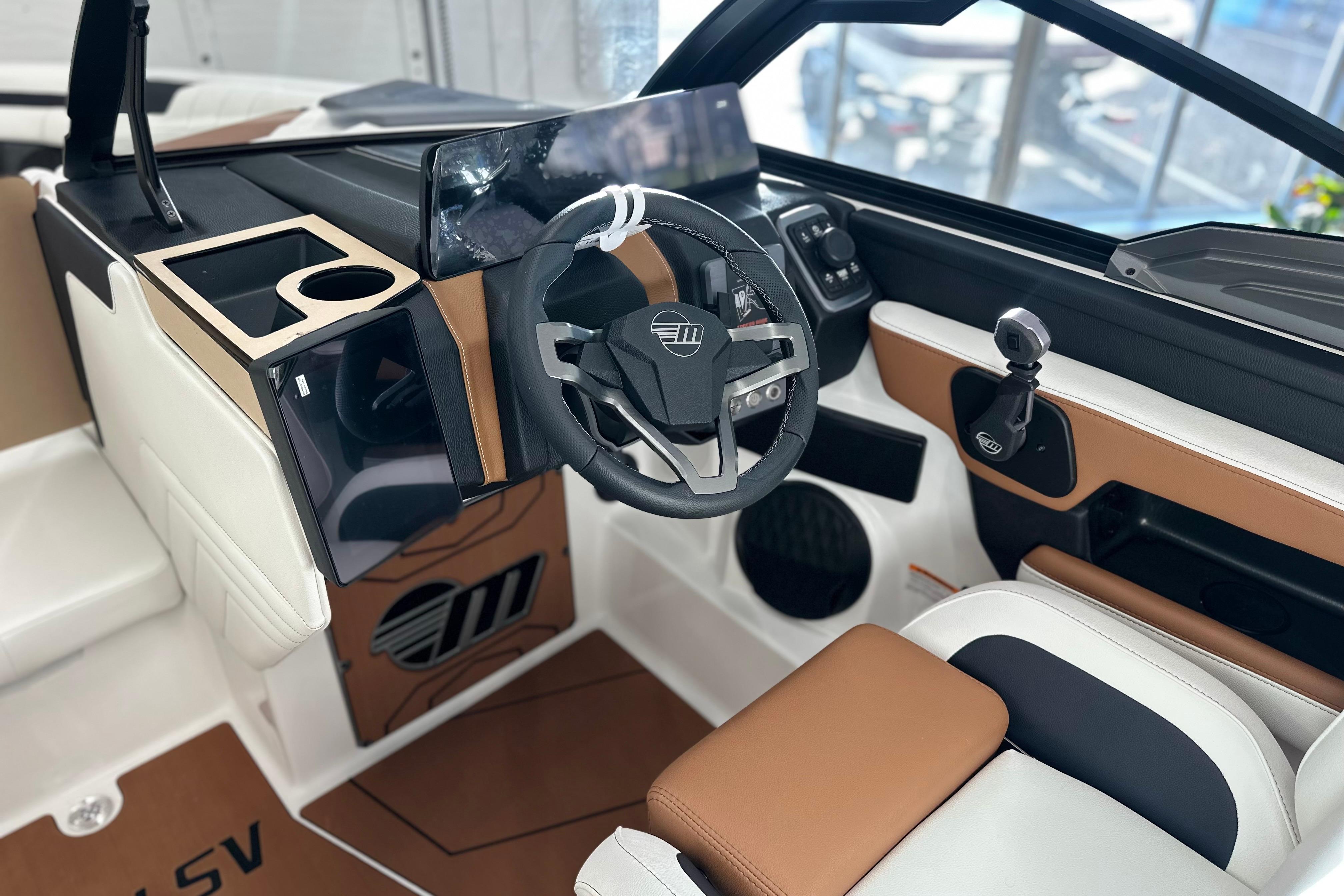 Interior of 2026 Malibu Wakesetter 25 LSV boat, featuring modern steering and controls.