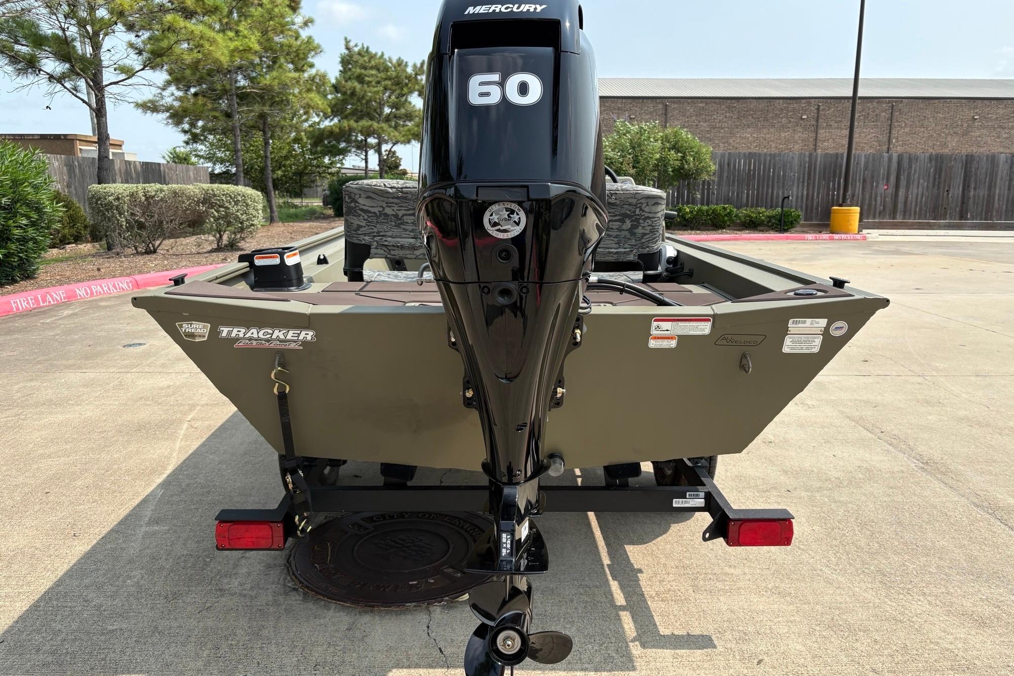 2026 Tracker Grizzly 1754 SC boat with Mercury 60 engine, parked outdoors.