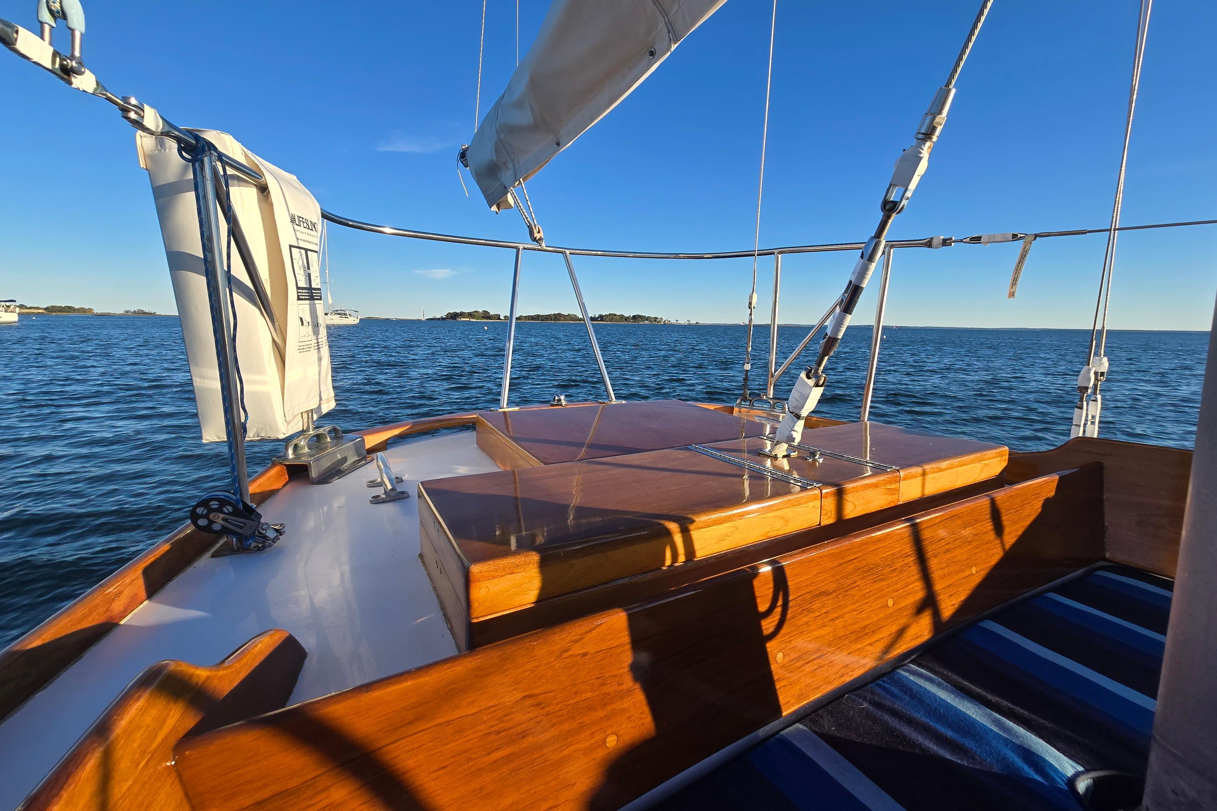 1970 Hinckley Bermuda 40 sailboat deck with ocean view under clear blue sky.