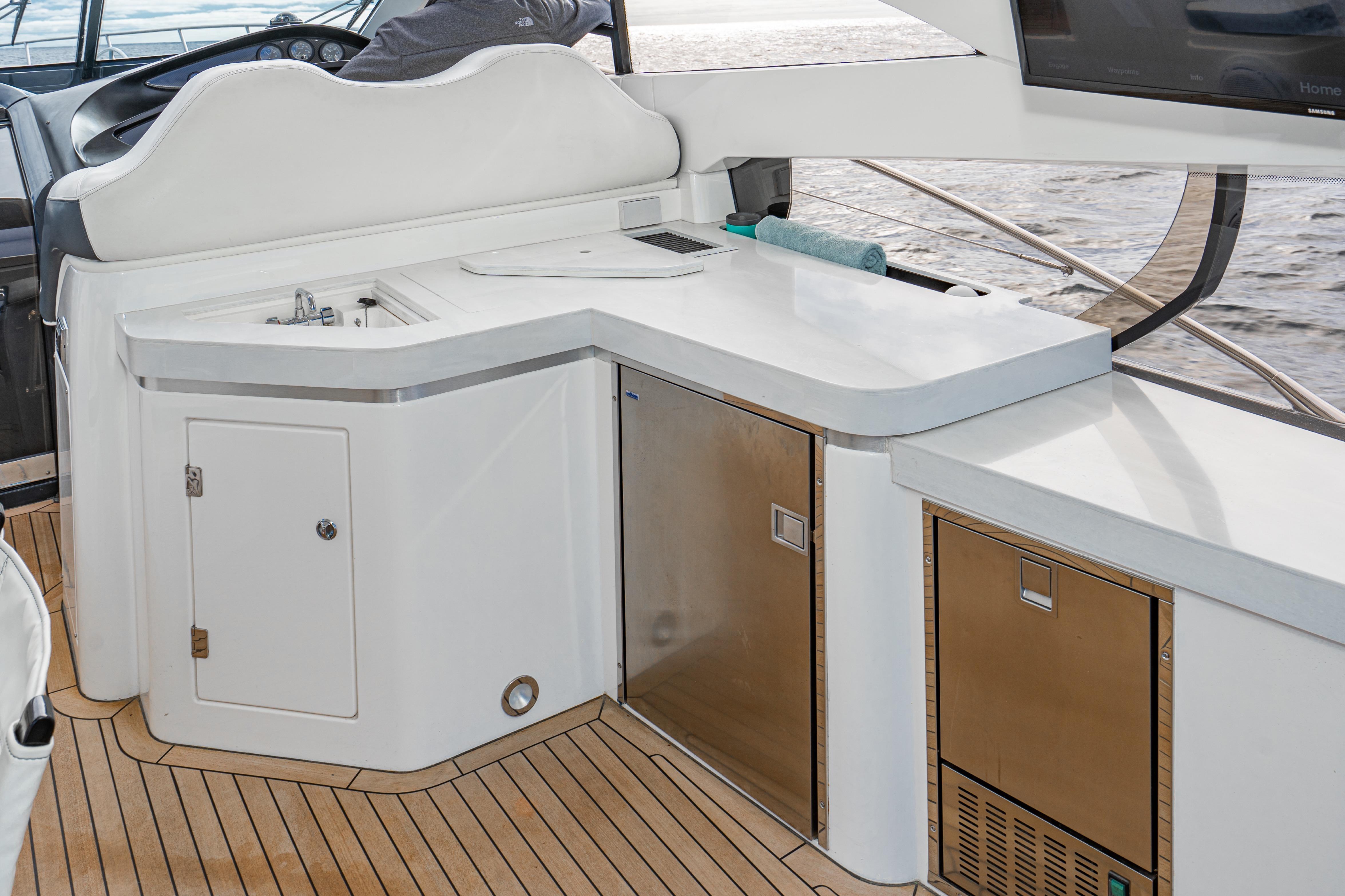 Luxurious Sunseeker Predator 68 yacht interior with sleek kitchenette, 2021 model.