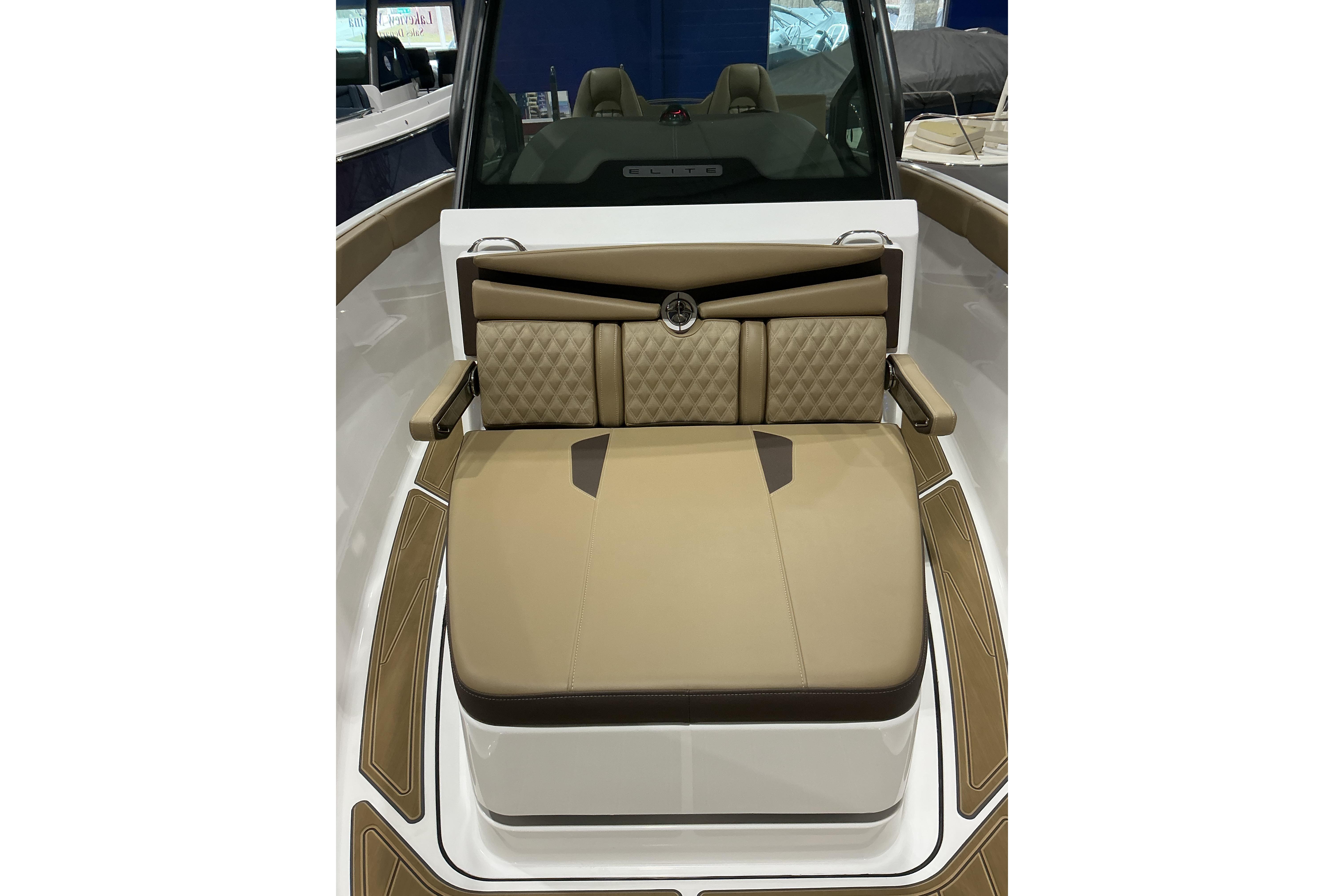 2026 Monterey Elite 25 SD boat interior with tan cushioned seating.