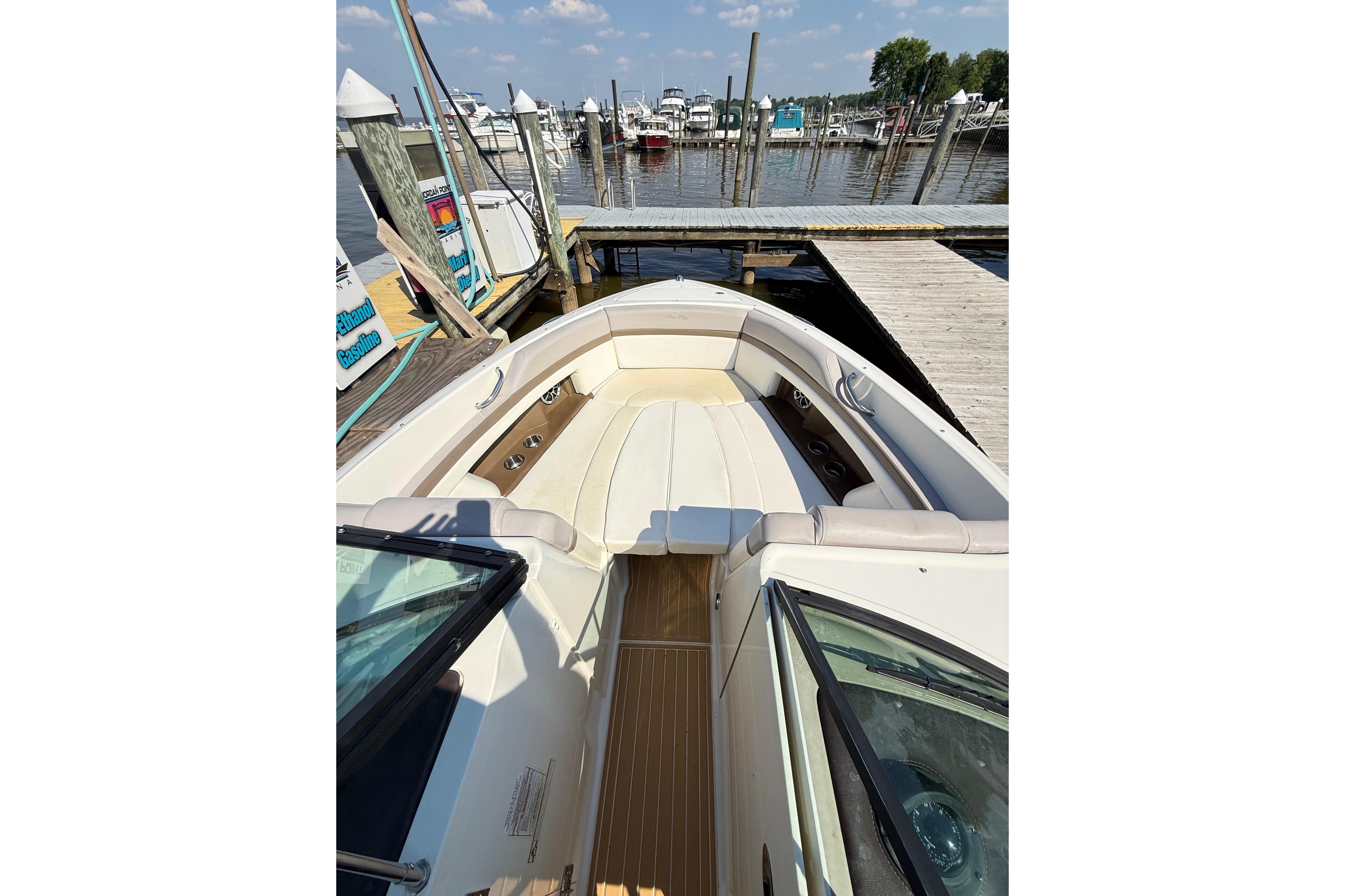 2011 Sea Ray 270 SLX boat docked at marina, featuring spacious seating and sleek design.