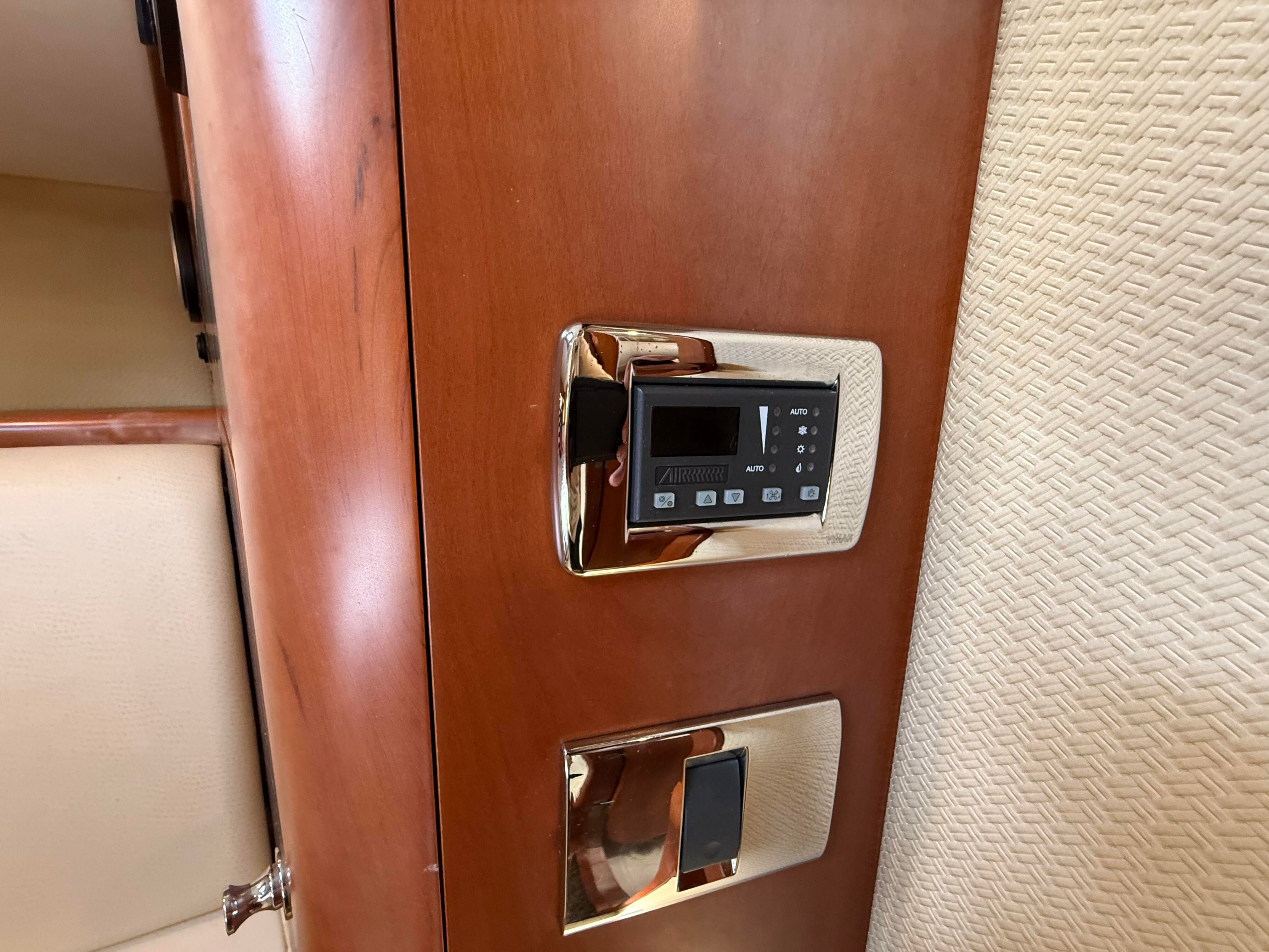 Close-up of a wooden cabinet with a built-in control panel.