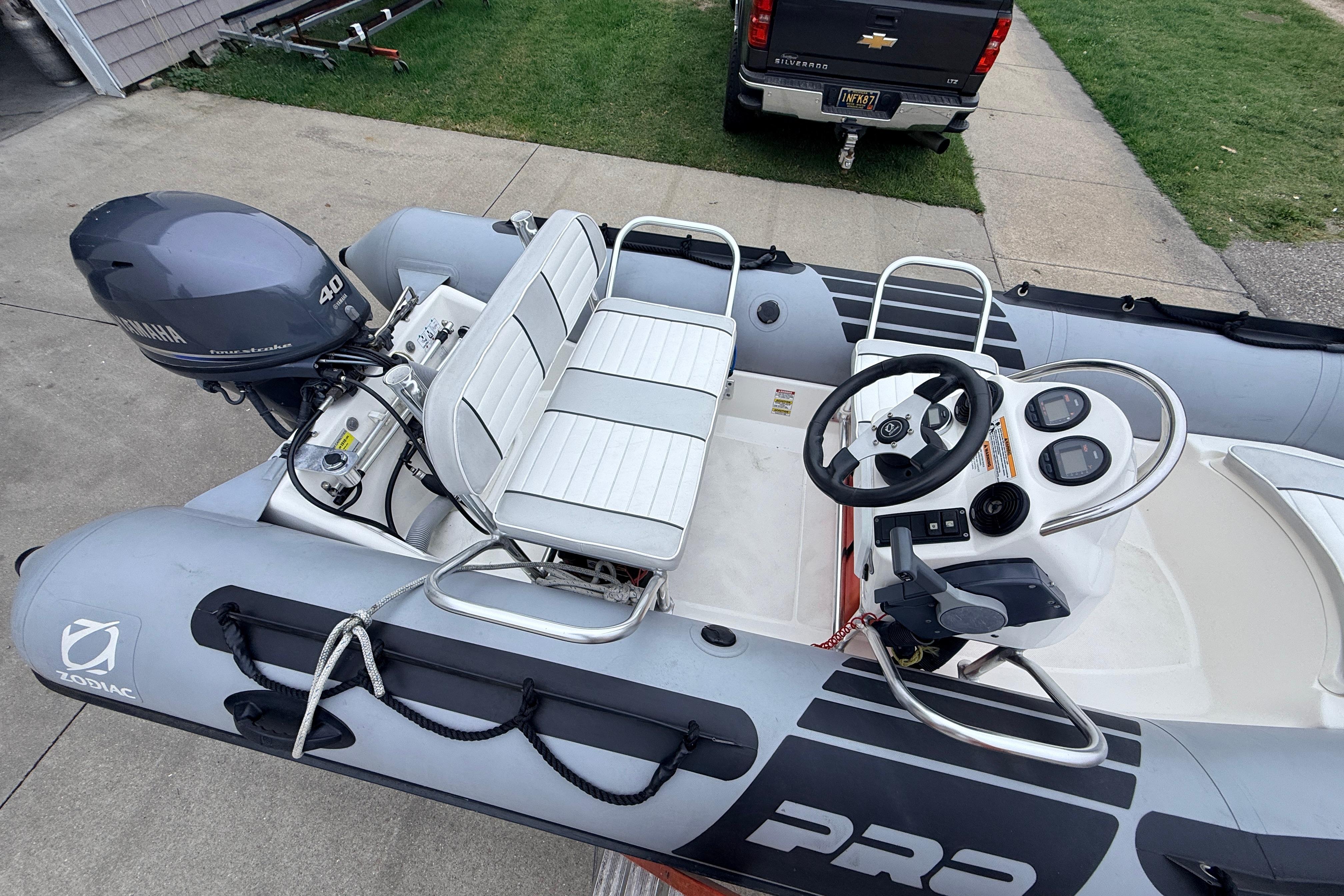 2014 Zodiac Pro Classic 420 inflatable boat with Yamaha 40HP engine, parked on driveway.