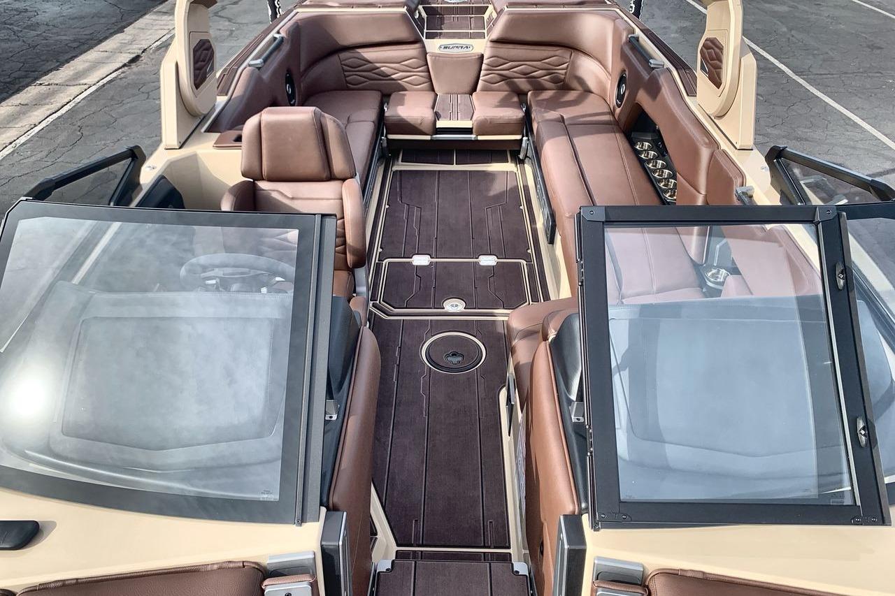 2026 Supra SE 550 boat interior with luxurious brown leather seating and sleek design.