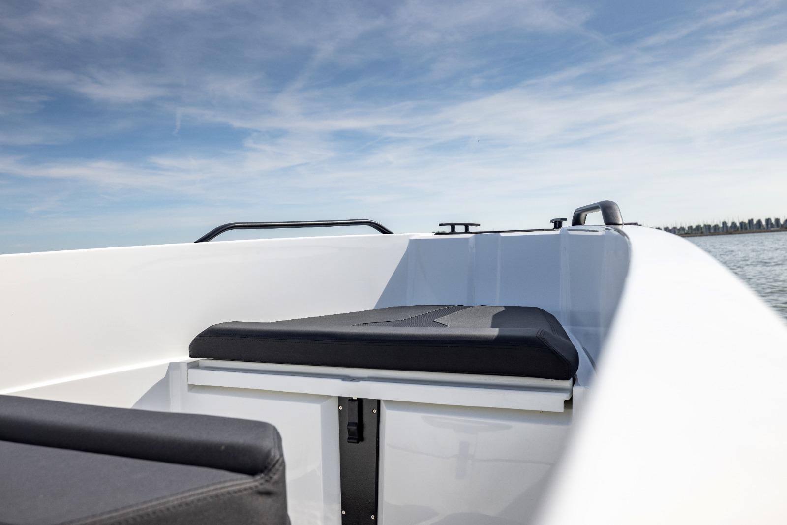 Modern Iron 707 boat interior, 2022 model, featuring sleek seating and open water view.