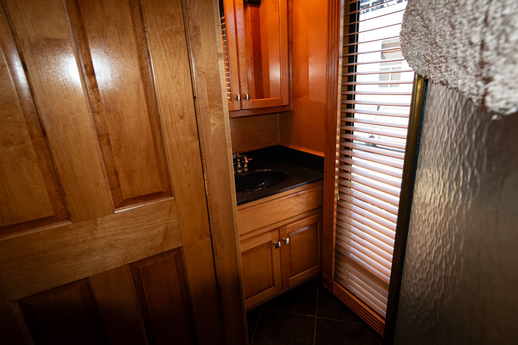 Wood-paneled bathroom in a 2003 Lakeview 16x70 houseboat.