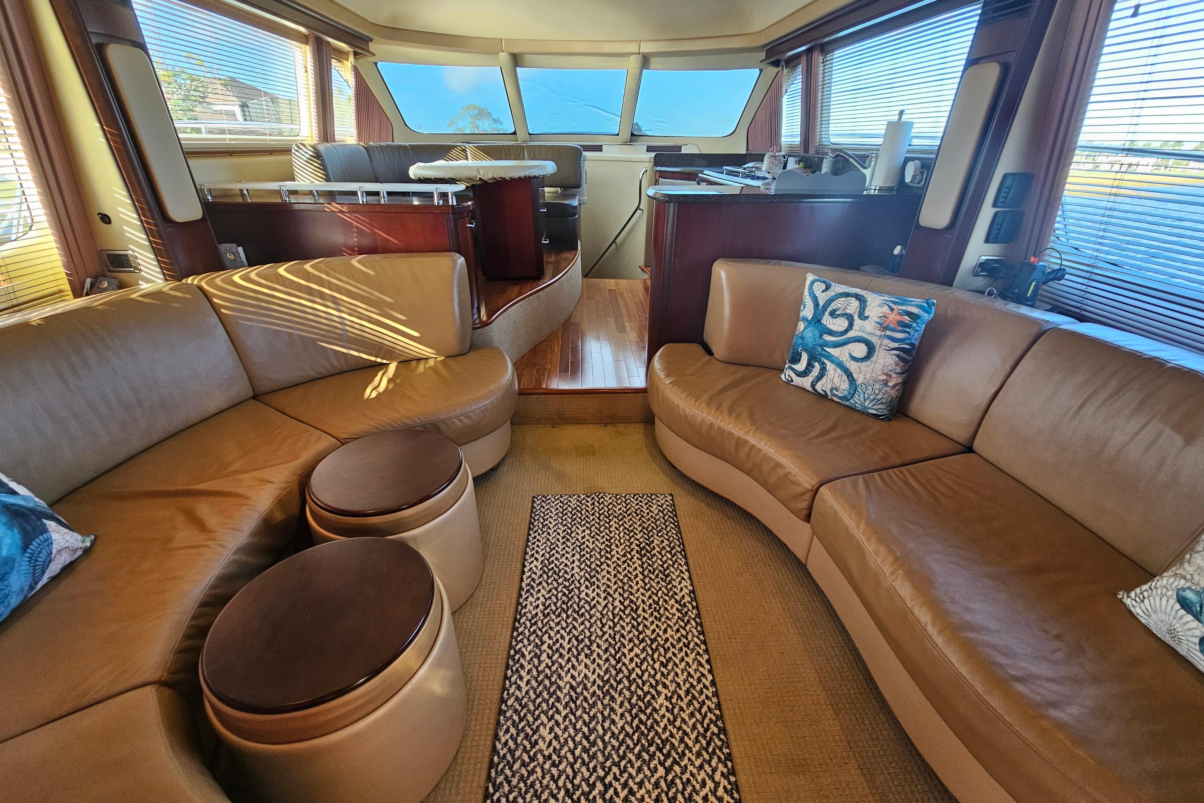 Luxurious interior of 2006 Sea Ray 580 Sedan Bridge yacht with leather seating and elegant decor.