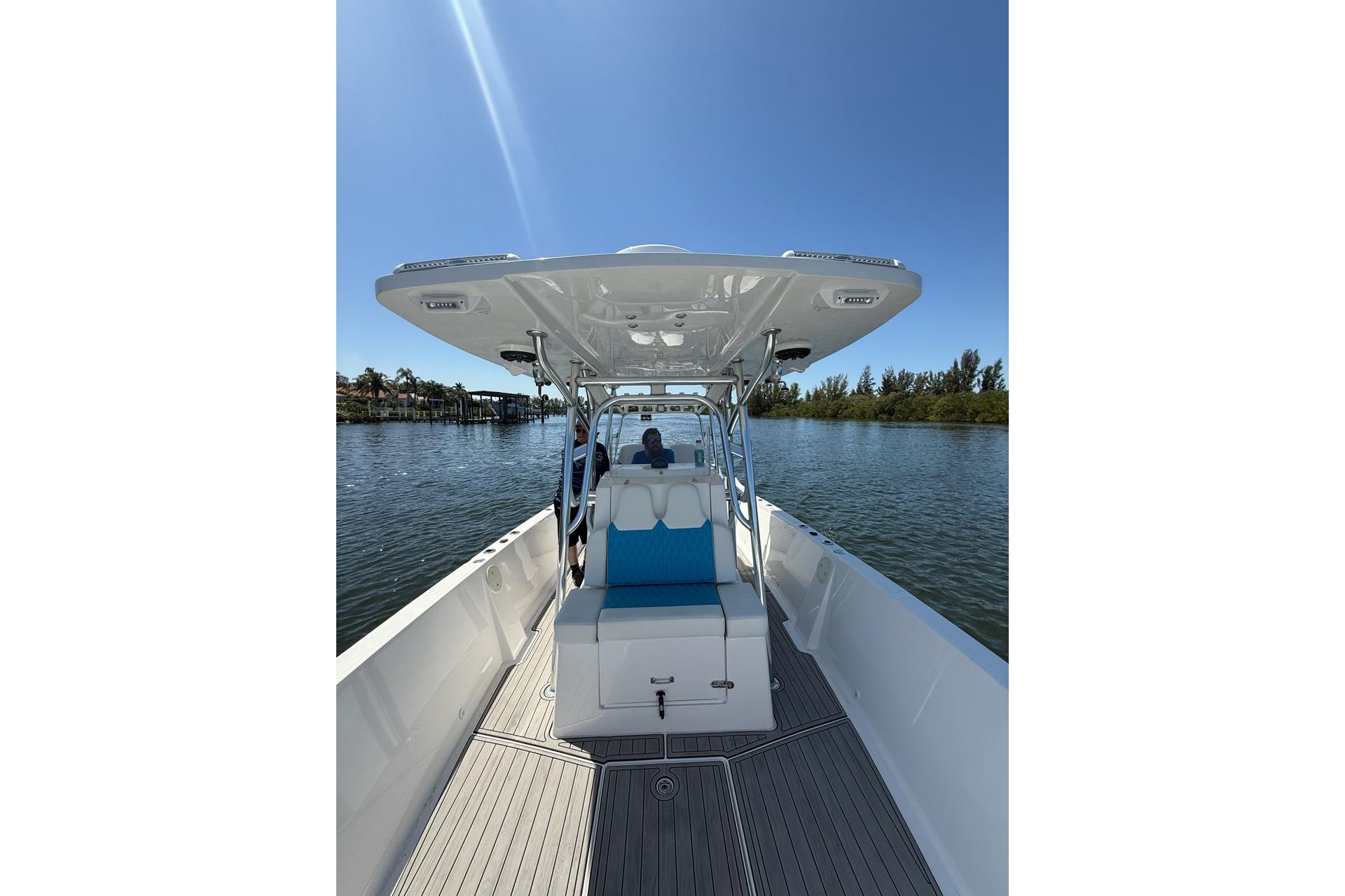 2021 Custom Infusion 34 CC boat on calm water under clear blue sky.