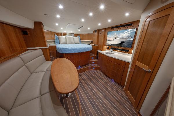 Luxurious interior of 2025 Albemarle 36 Express yacht with wood finishes and cozy seating.