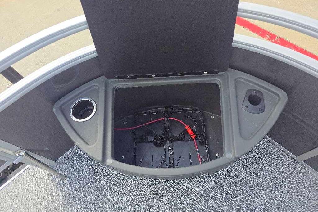 2026 Sun Tracker Fishin' Barge 20 DLX storage compartment with cup holder and wiring.