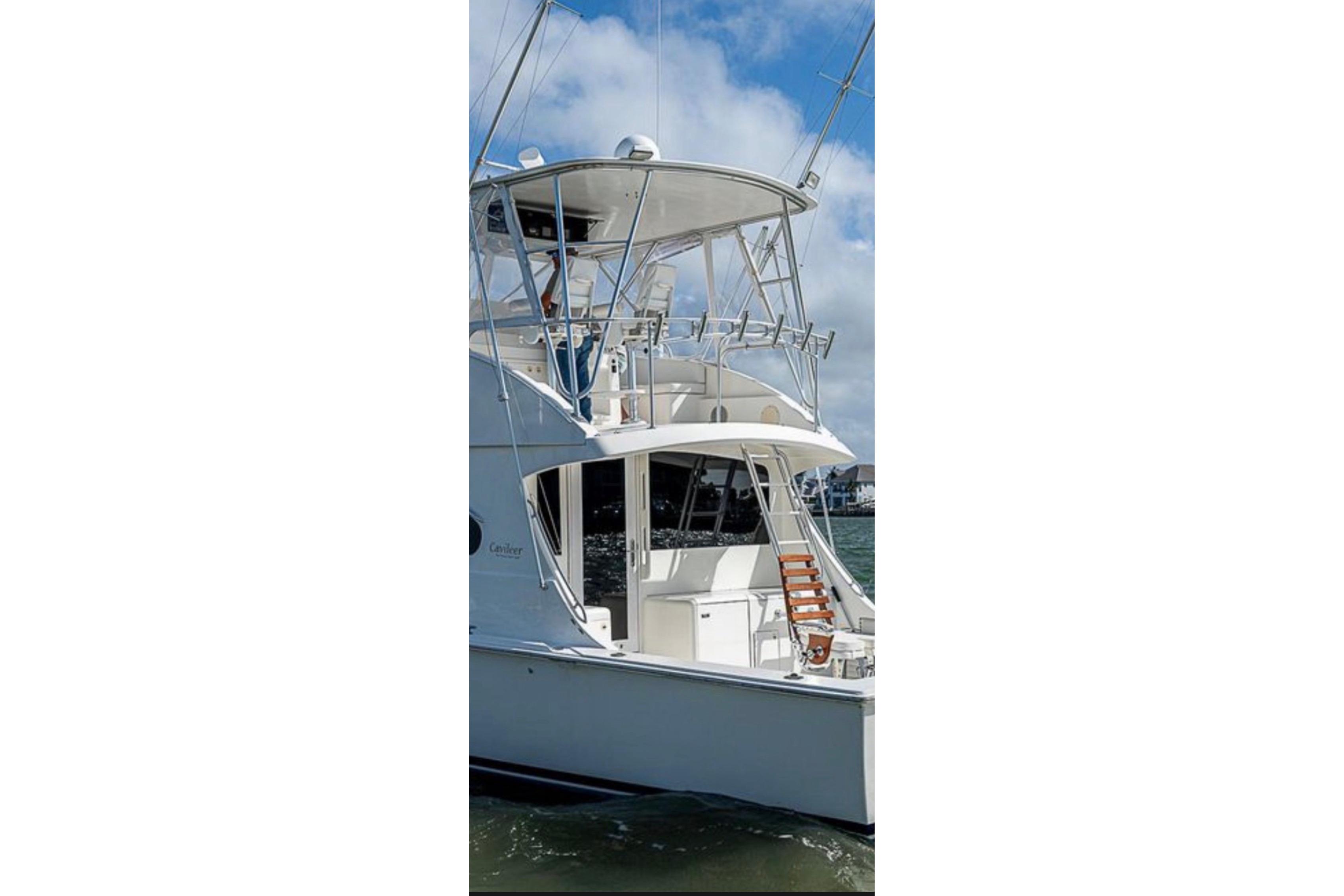 2001 Cavileer 53 Convertible yacht on water, featuring sleek design and spacious deck.