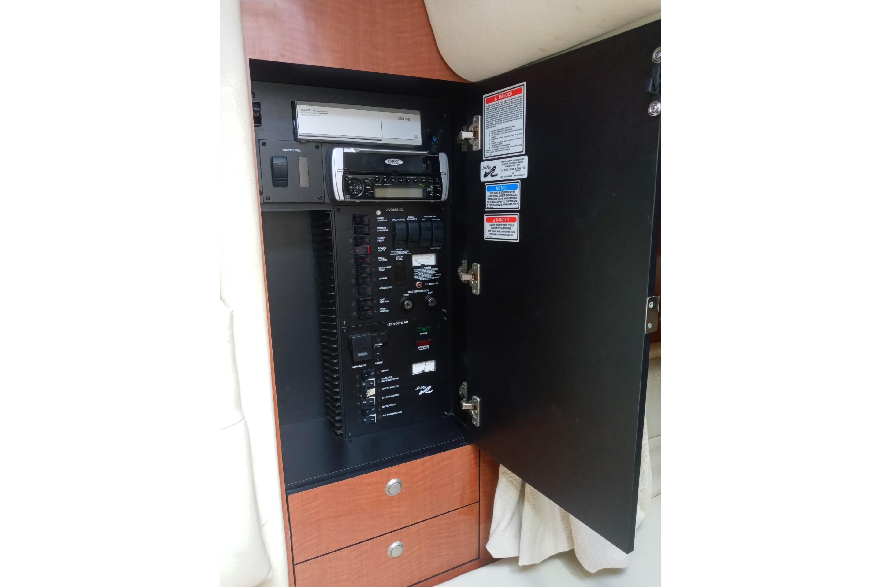 Electrical panel inside 2005 Sea Ray 300 Sundancer boat, featuring control switches and stereo system.