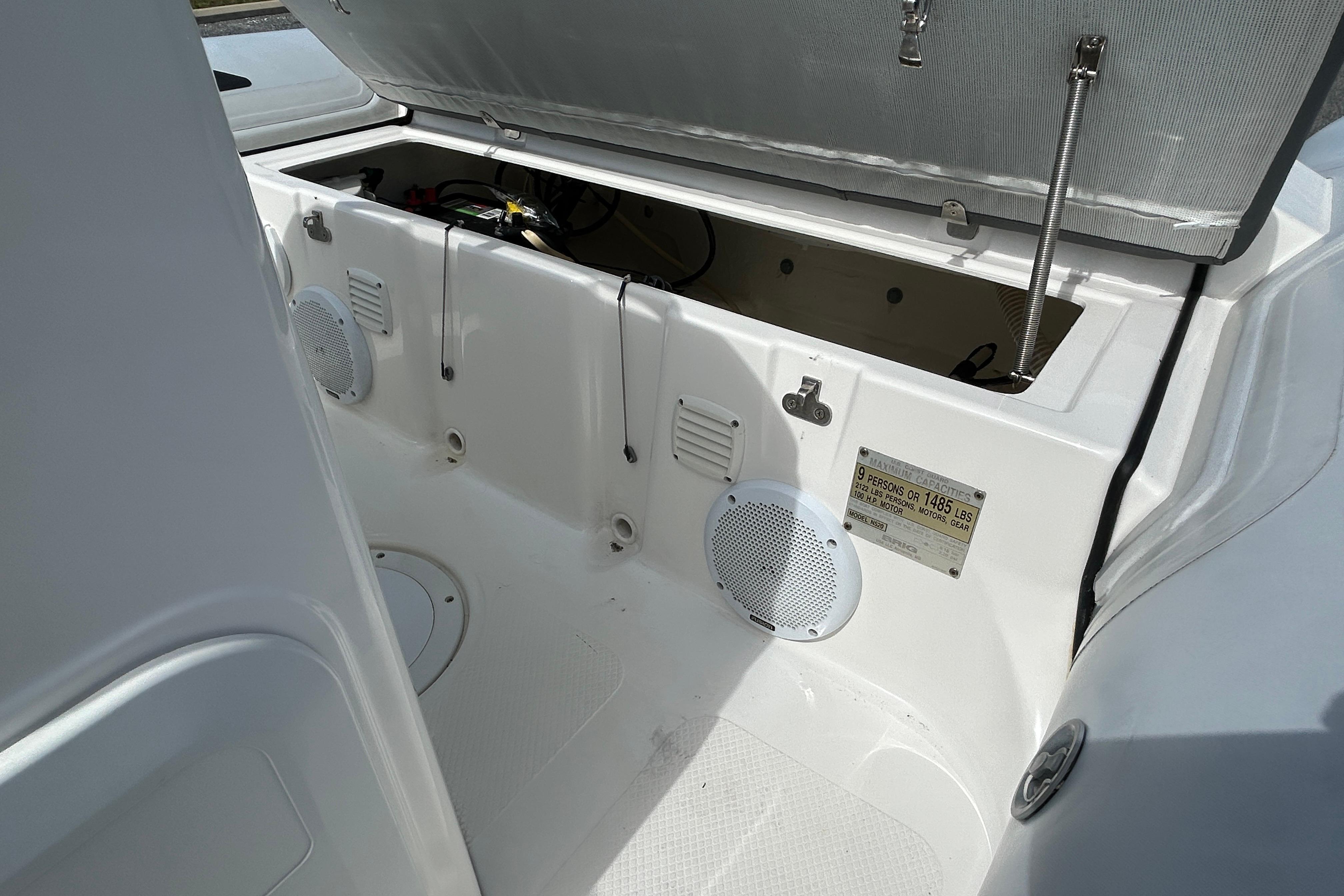 2016 Brig Navigator 520 boat interior with open storage compartment and speaker.