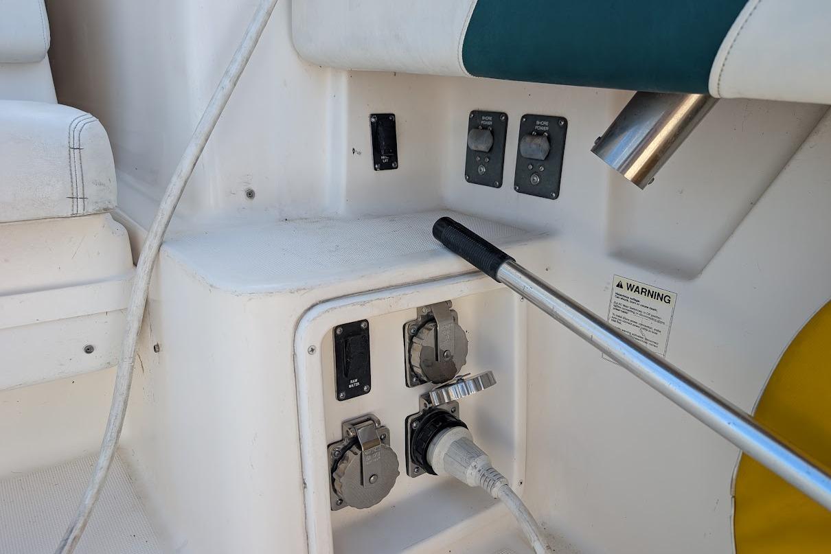 Control panel and power connections on a 2000 Pursuit 3400 Express boat.