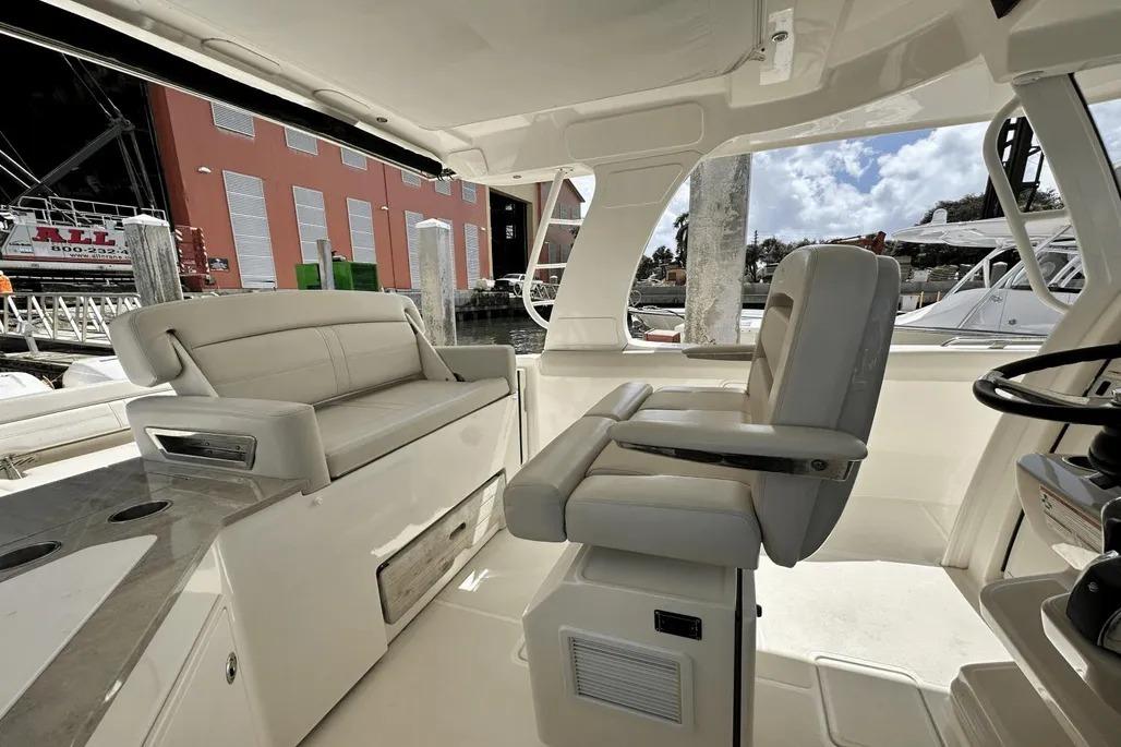 2019 Boston Whaler 350 Realm interior with plush seating and helm station.