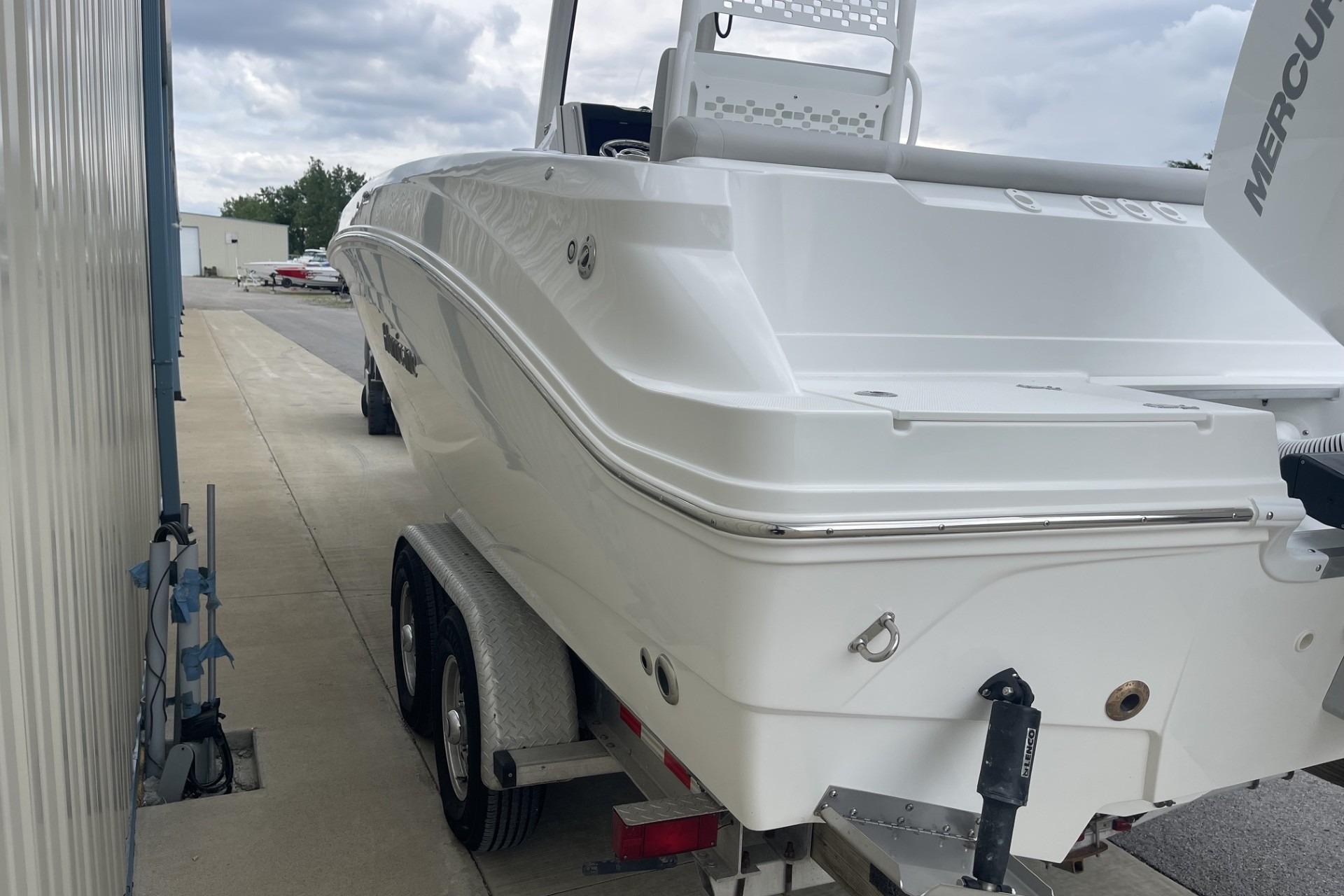 2026 Hurricane Center Console 24 OB boat on trailer, parked outdoors.