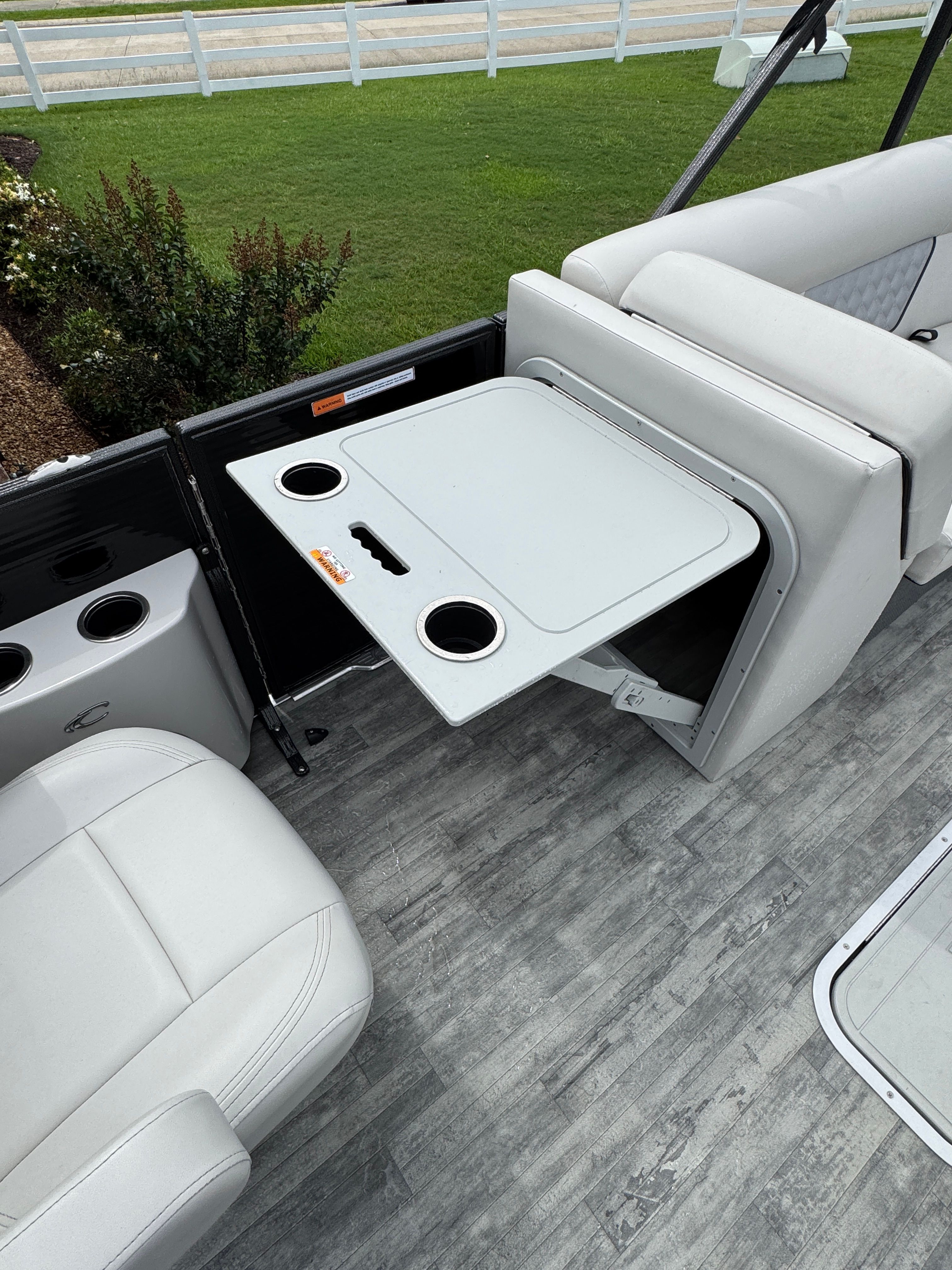 Interior of Crest Classic DLX 220 boat with fold-out table.