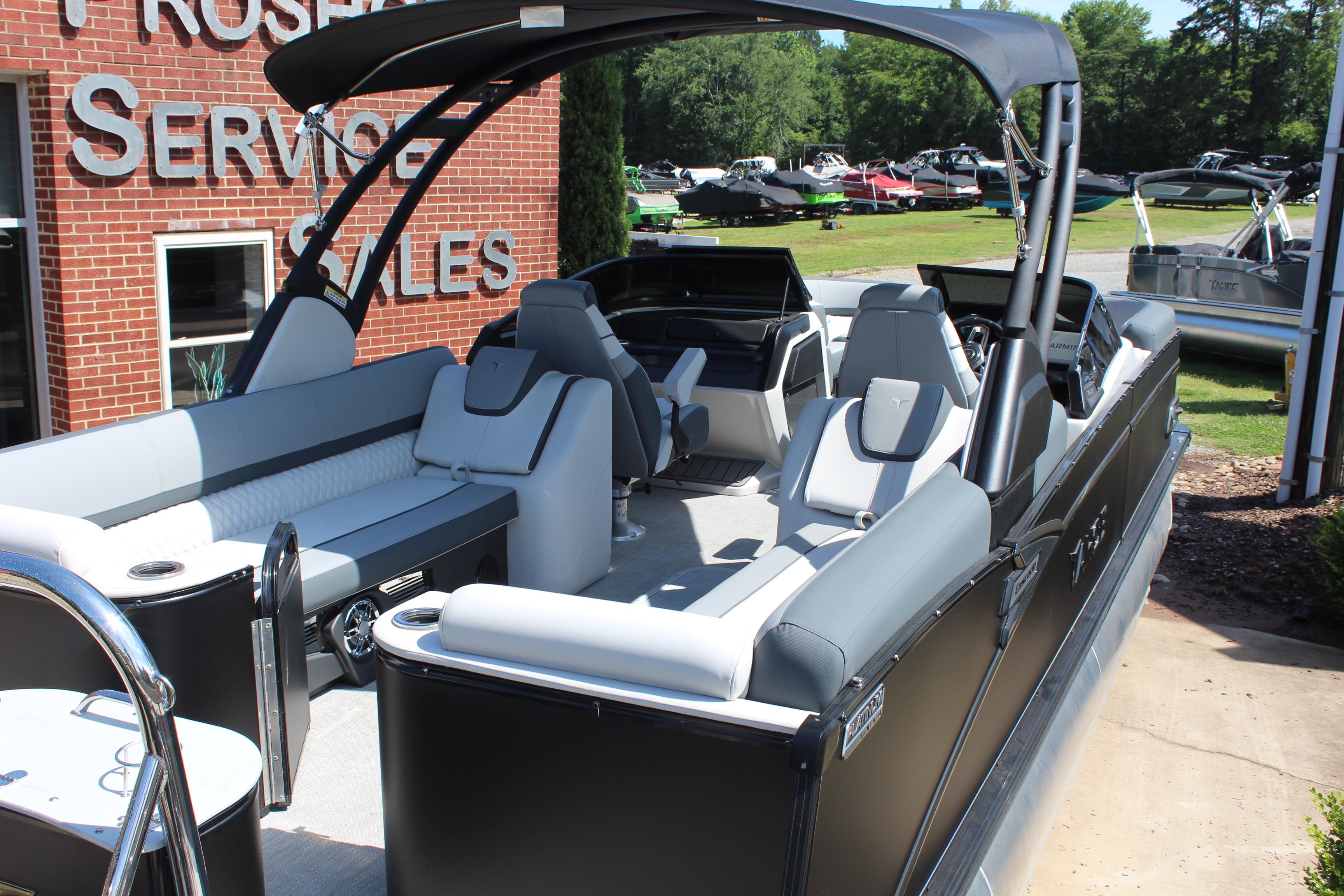 2025 Tahoe Pontoon Cascade Quad Lounge Windshield at dealership, showcasing luxurious seating and design.