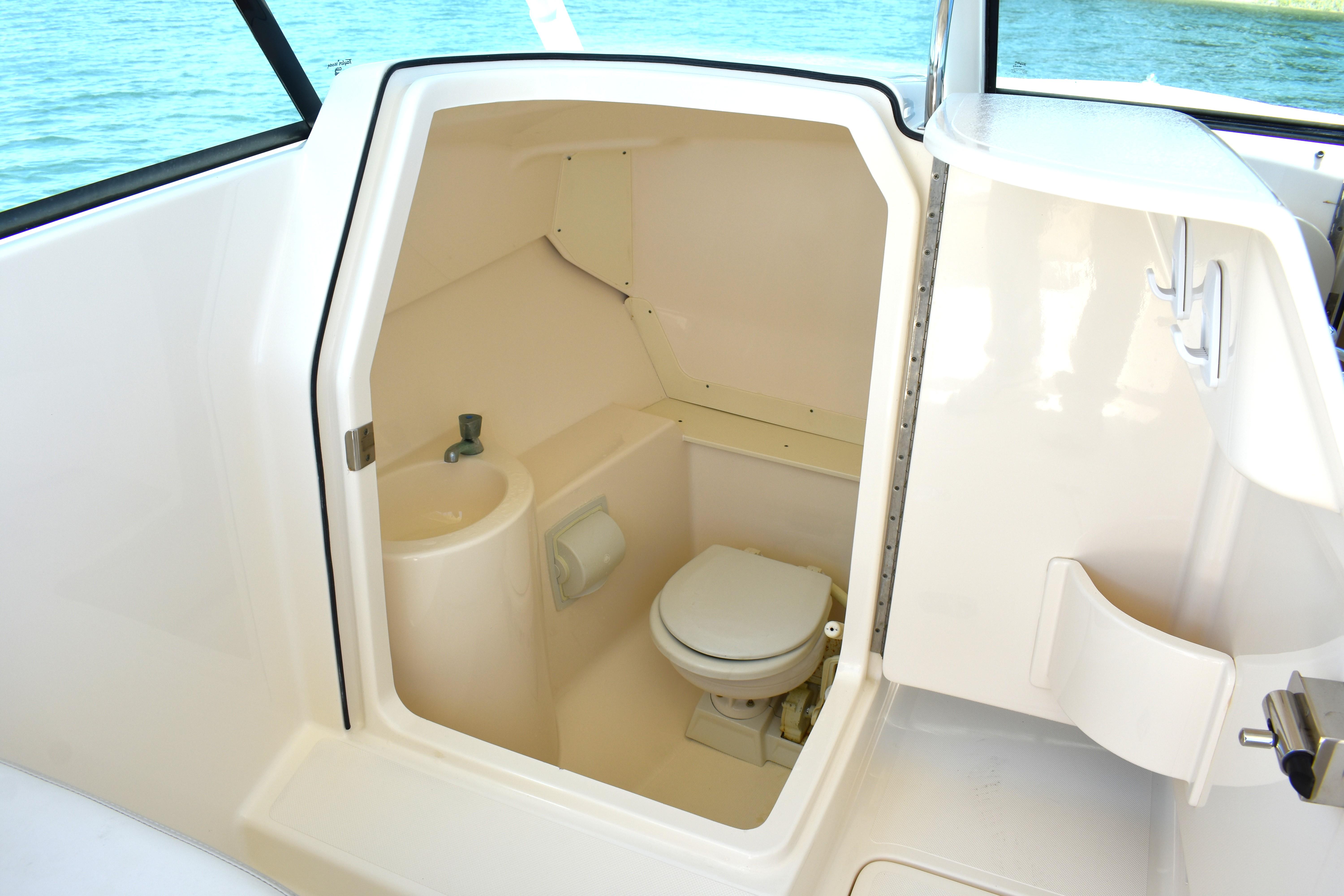 2012 Pursuit DC 265 Dual Console boat interior with compact marine toilet.