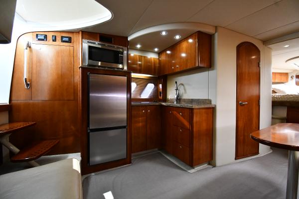 Interior of 2010 Cruisers Yachts 390 Sports Coupe with modern kitchen amenities.