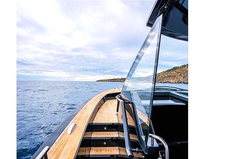 Windy SR52 yacht cruising on open sea, showcasing sleek design and wooden deck, 2013 model.