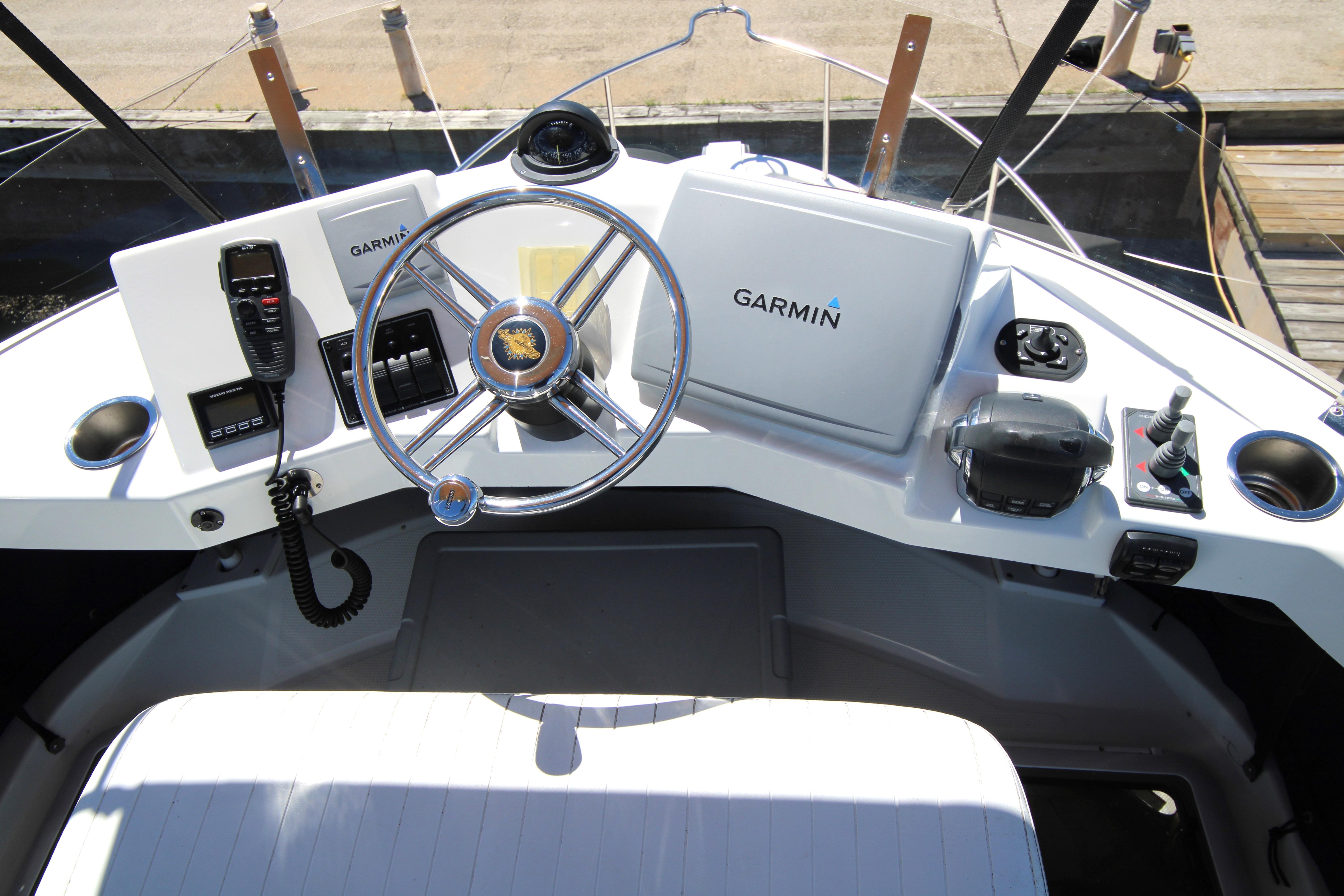 Helm of 2013 Ranger Tugs R-31 CB with Garmin navigation system and steering wheel.