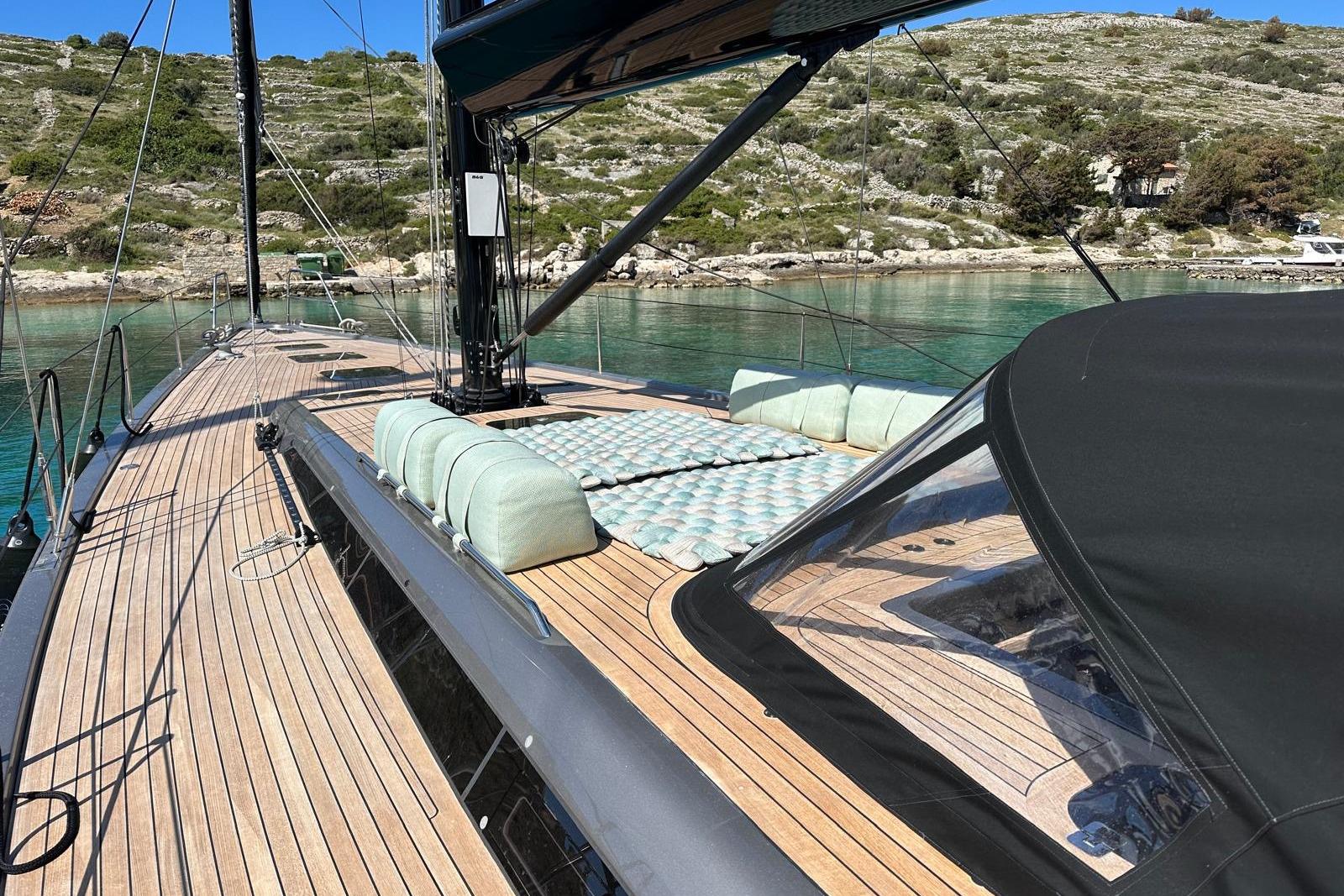 Luxurious 2023 Solaris 55 yacht with sleek deck design, anchored in serene waters.