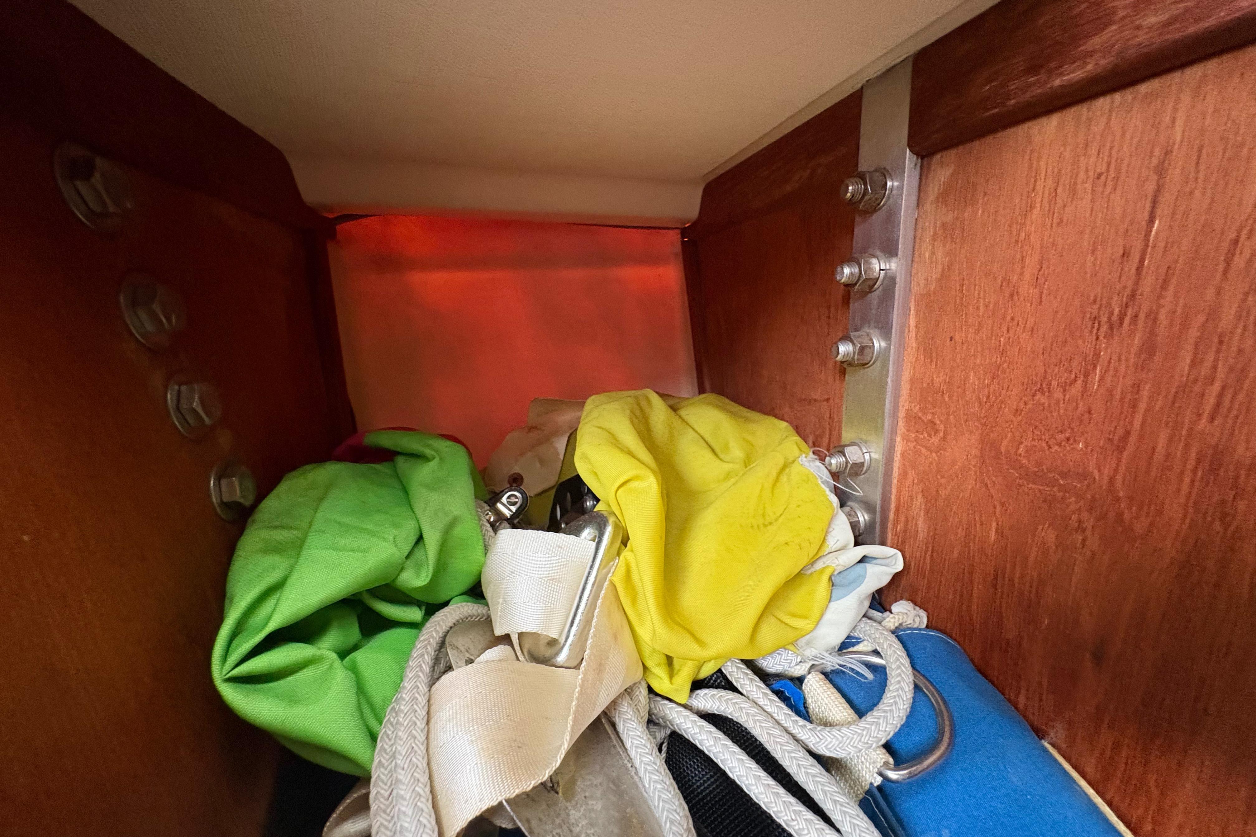 Interior of 1981 Sabre 31 sailboat with colorful ropes and fabric storage.