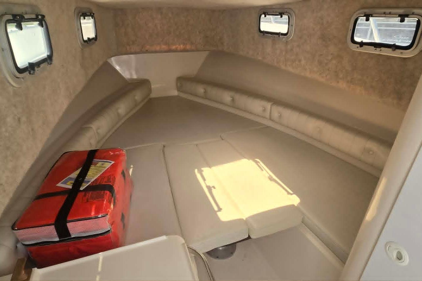 Interior cabin of 2003 True World Marine 286 boat with seating and windows.