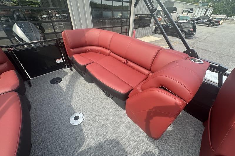 Red leather seating on 2026 Regency 230 DL boat, outdoor setting.