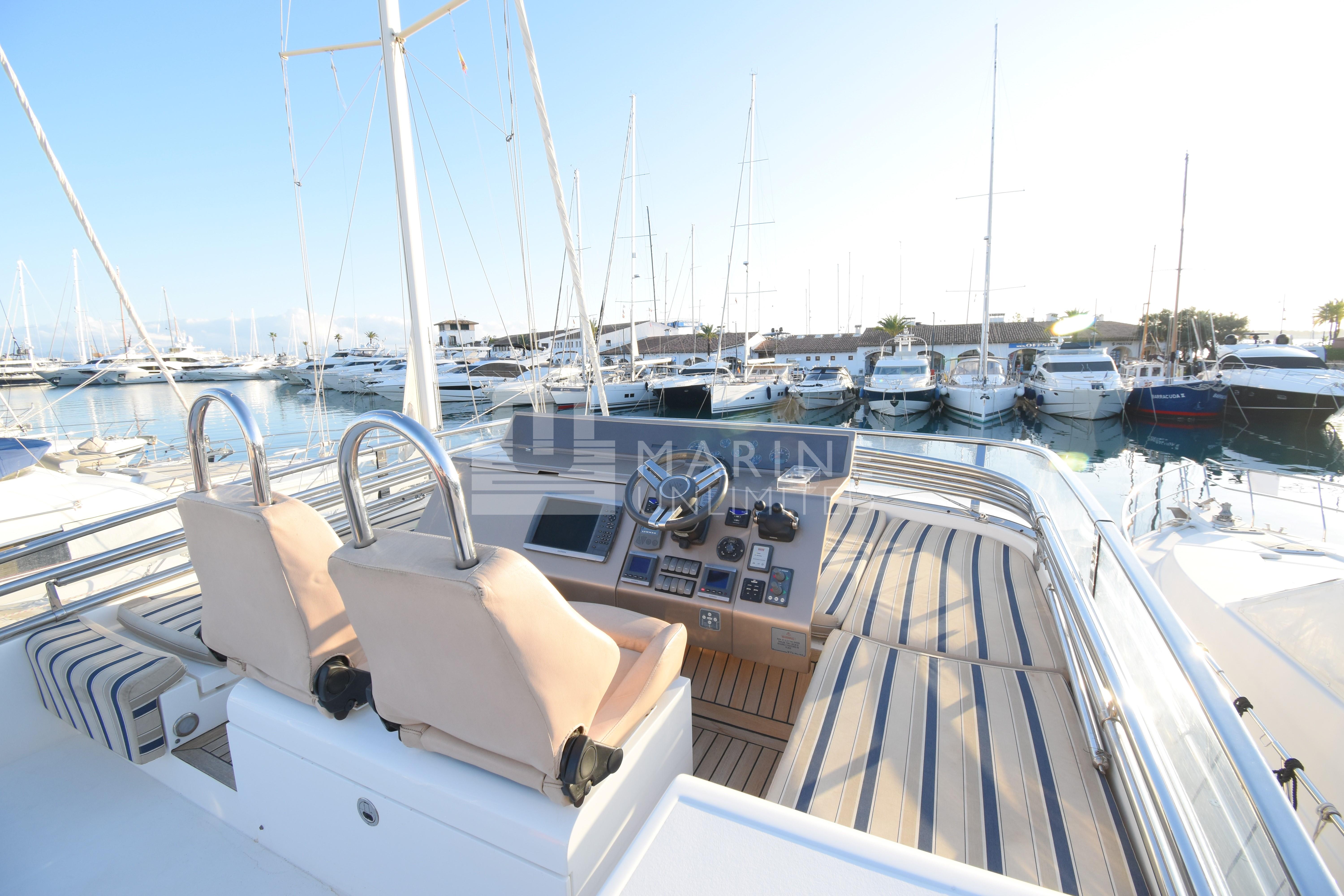 Luxury Fairline Squadron 55 yacht helm, 2010 model, docked in a marina.