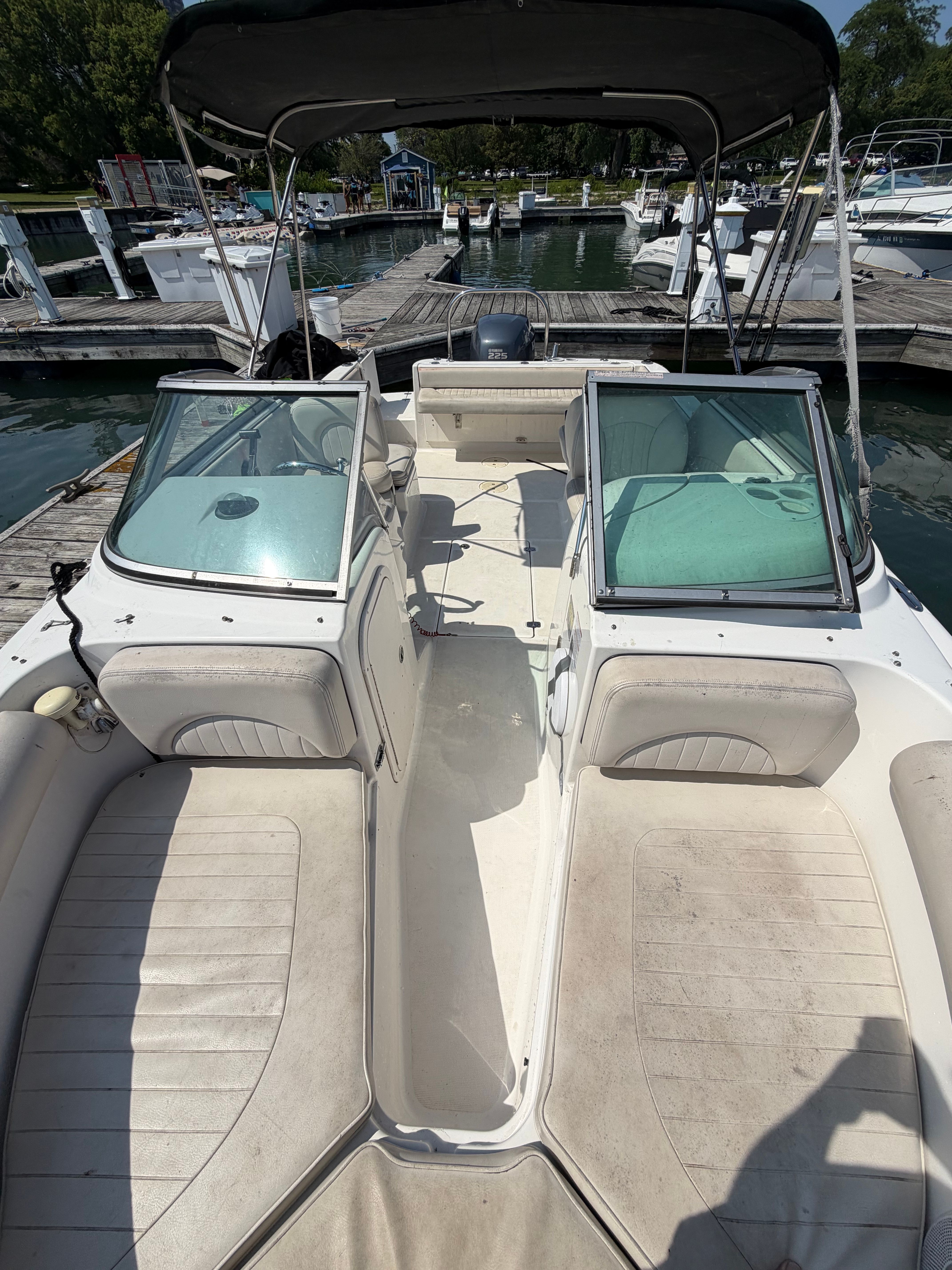 A 2005 Robalo R227 Dual Console boat at a dock. It features dual consoles and seating.