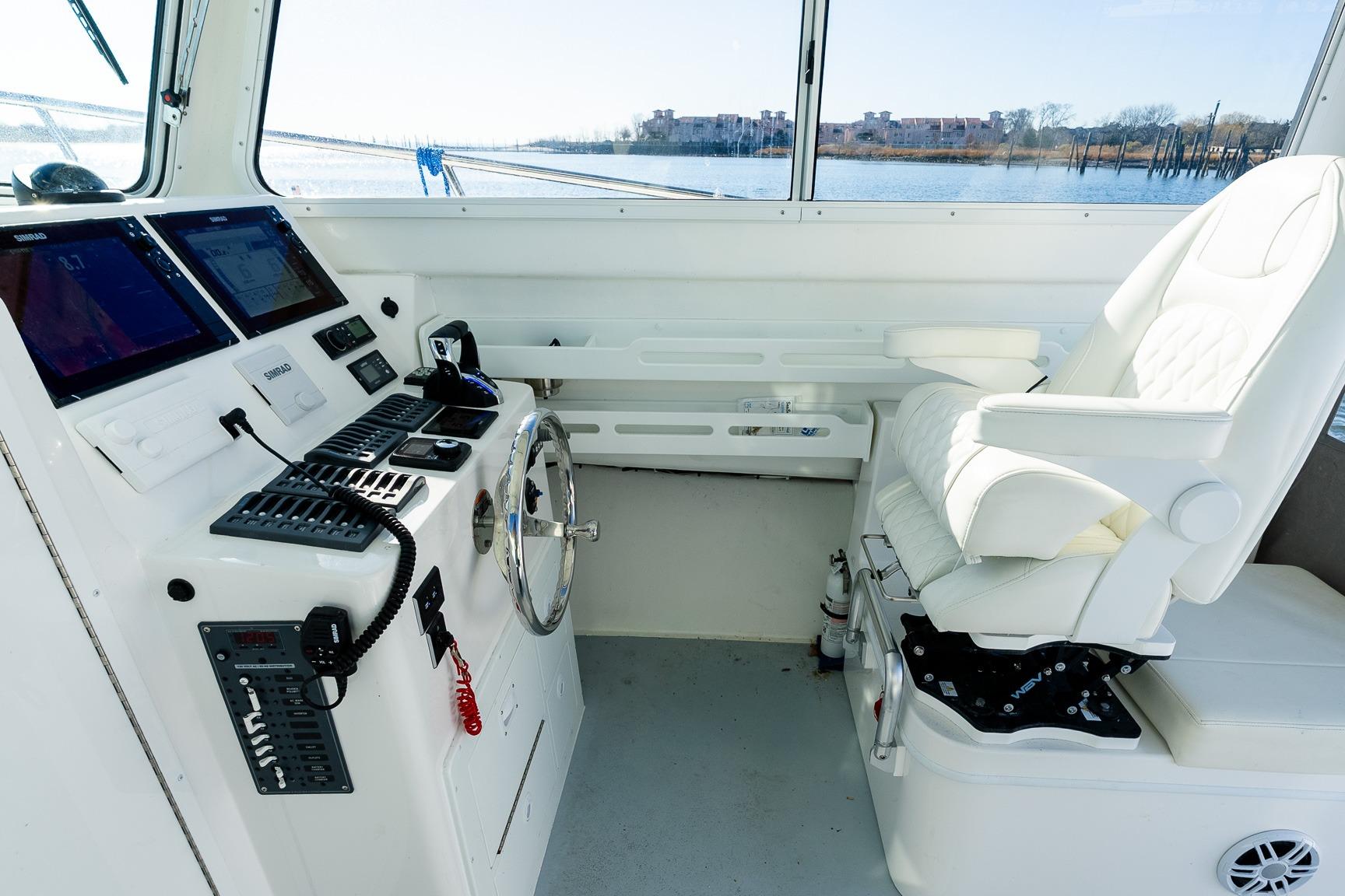 2024 Steiger Craft 31 Fisherman helm with modern controls and comfortable captain's chair.