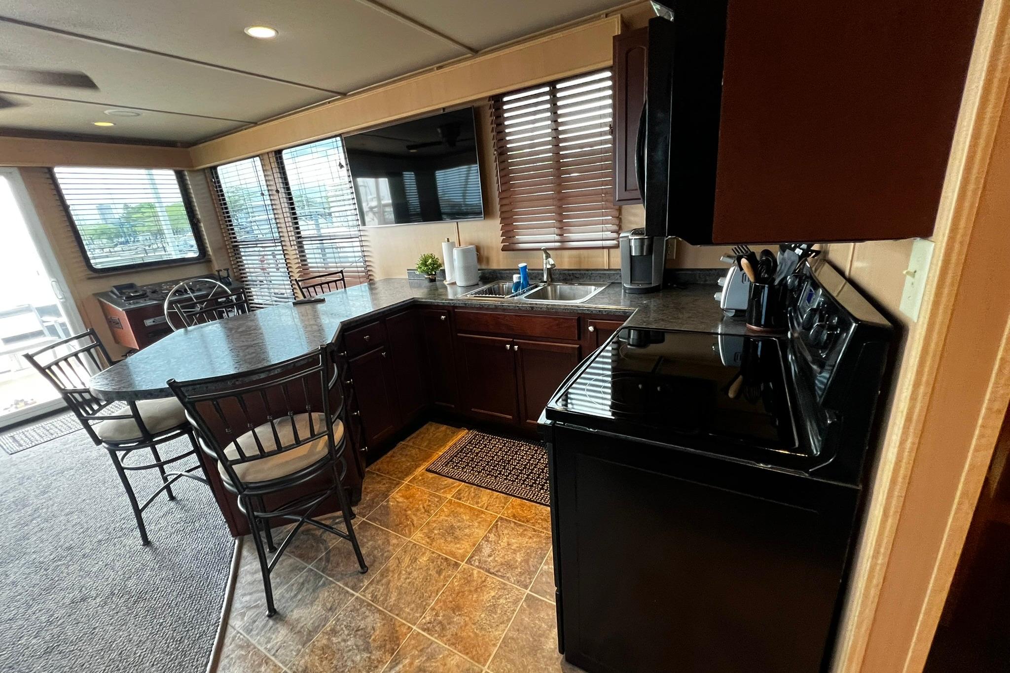 Interior of 2010 Skipperliner 480 Flybridge with modern kitchen and dining area.
