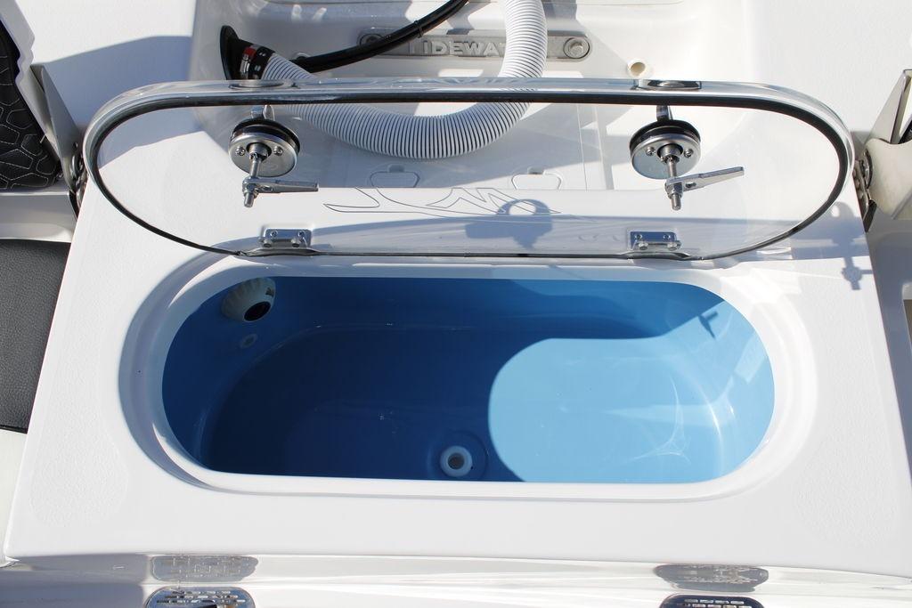 Livewell on 2026 Tidewater 2110 Bay Max boat, open lid, blue interior.