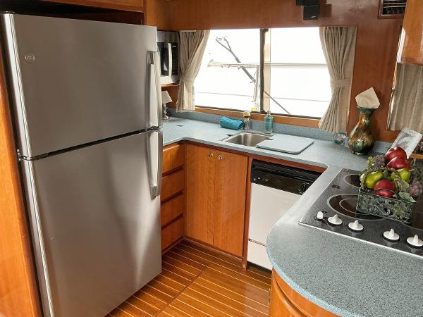 Novatec Islander 55 yacht kitchen, 2000 model, featuring modern appliances and wooden cabinetry.