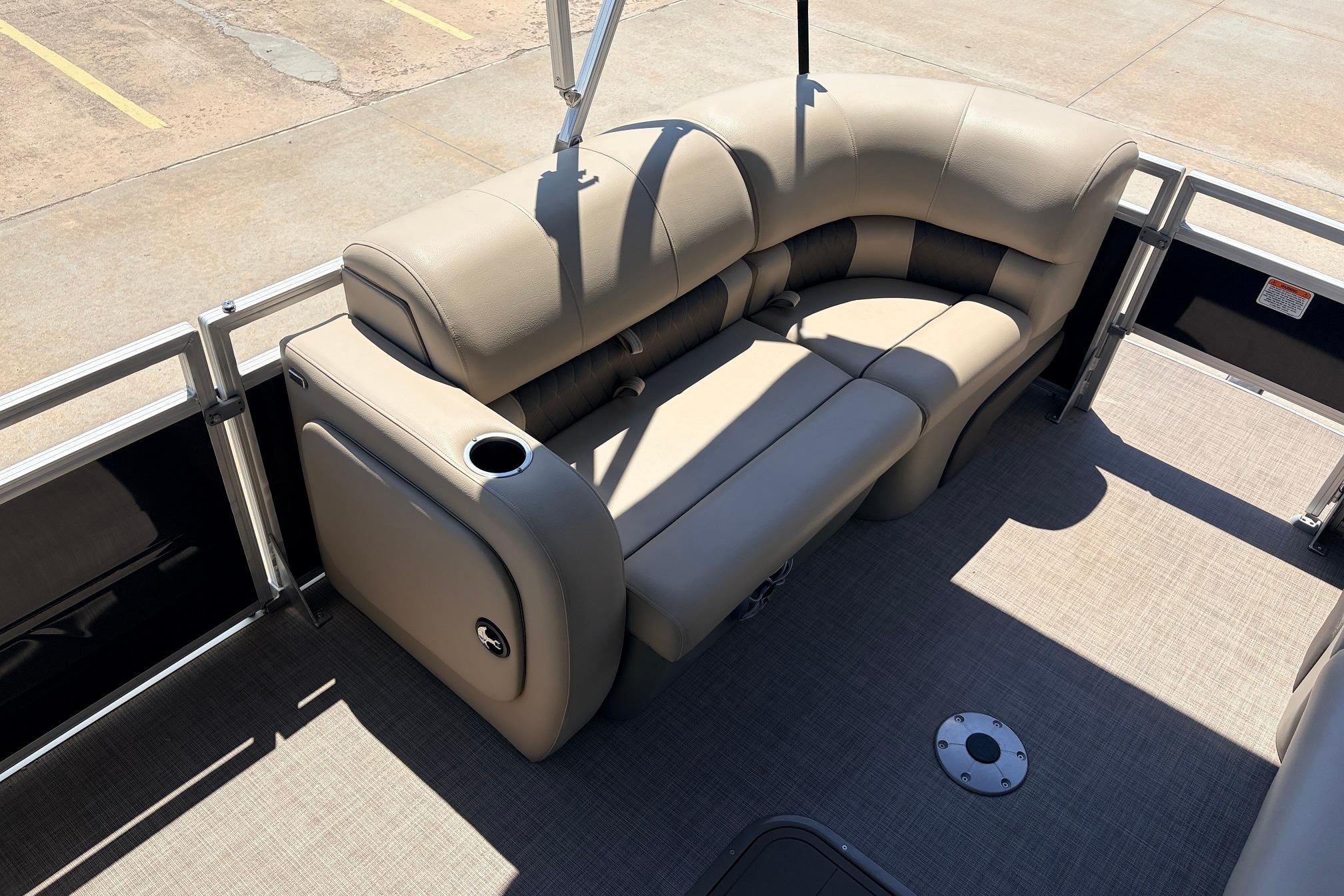 2024 Sun Tracker SportFish 22 XP3 pontoon boat interior with beige seating and cup holder.