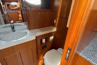 2007 Island Pilot 395 yacht bathroom with wood cabinetry and modern fixtures.