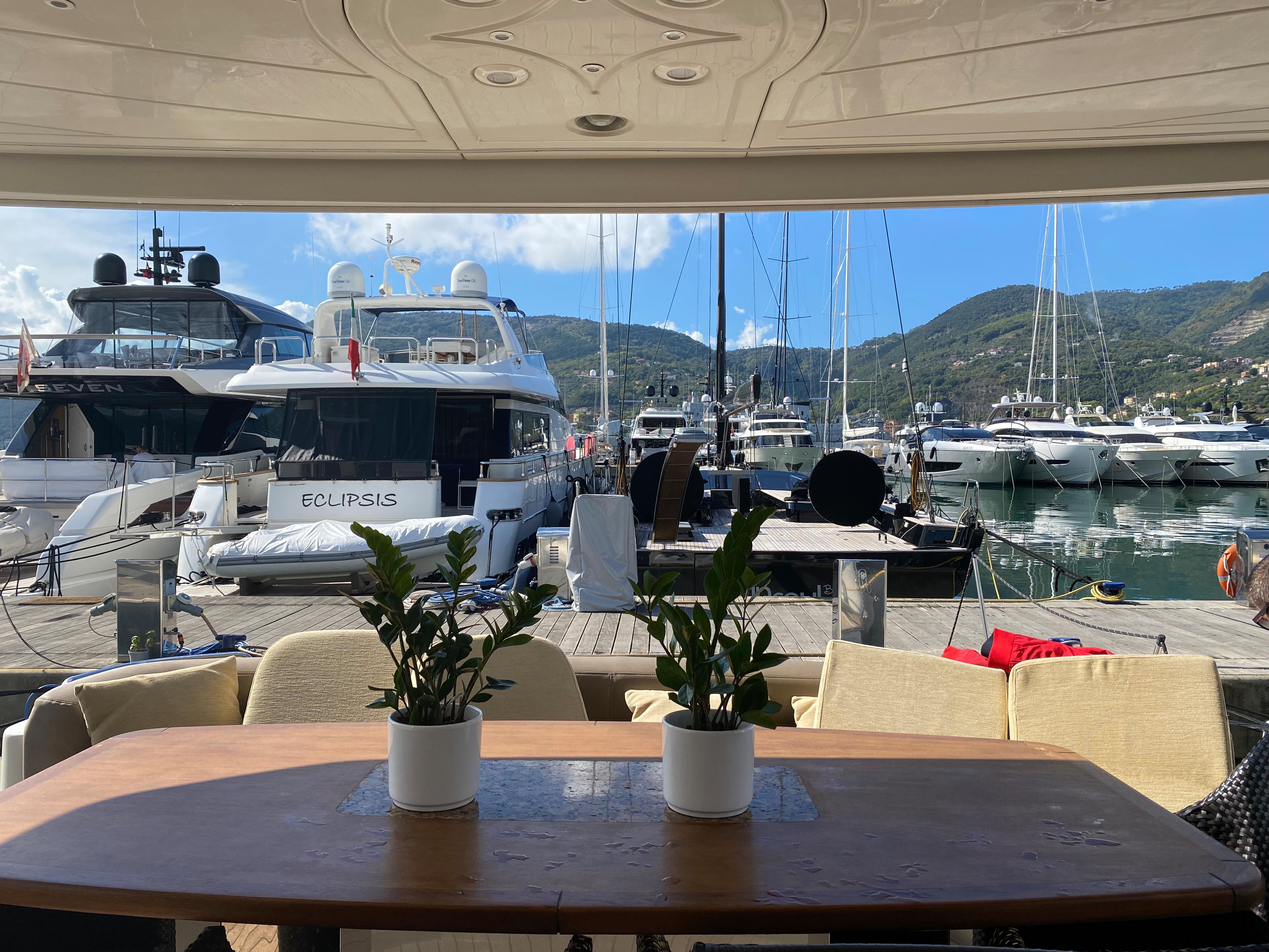 Luxury yacht marina view with potted plants on a table, Dominator 680, 2008 model.