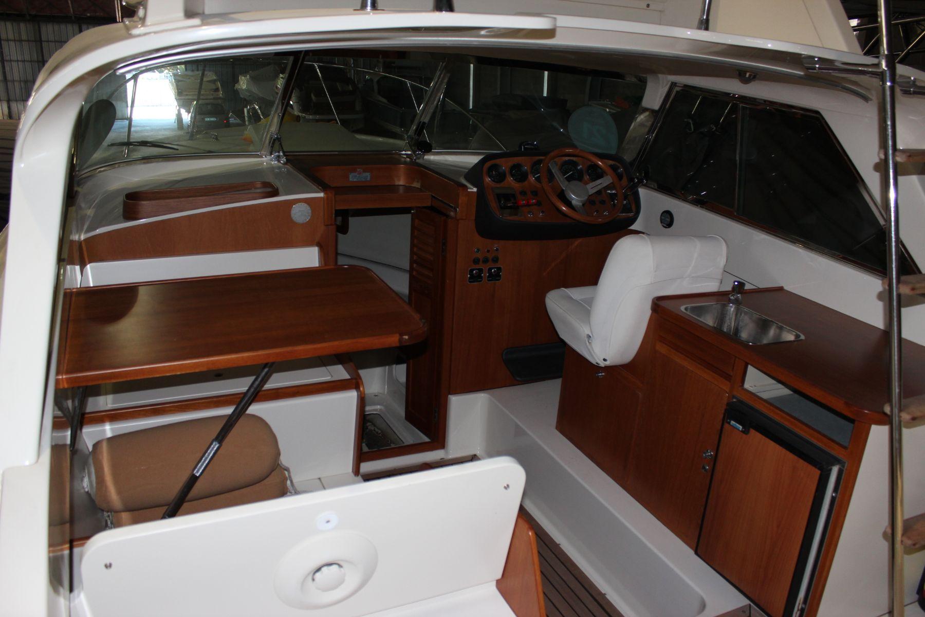 1974 Riva Bertram 25 Sportfisherman interior with wooden accents and steering console.