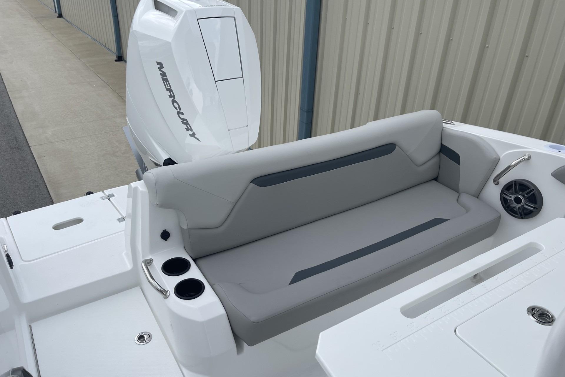 2026 Hurricane Center Console 24 OB boat with Mercury outboard engine and cushioned seating.